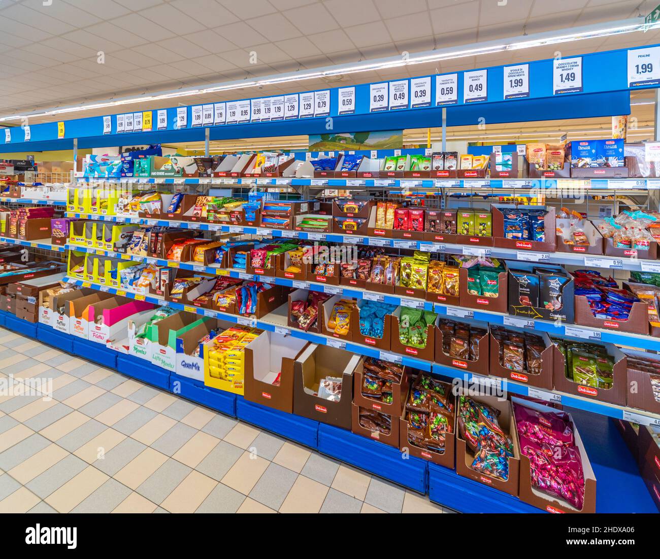 Fossano, Italy - October 29, 2021: shelves, for the sale of sweets, chocolate, snacks, candies, inside Eurospin discount supermarket. It is an Italian Stock Photo