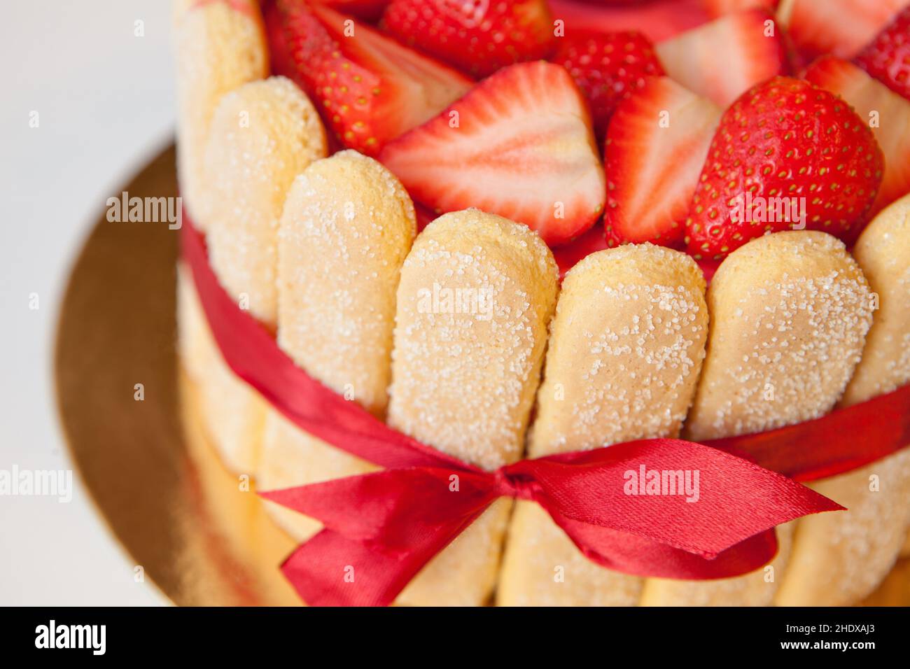 tiramisu cake close up with strawberries, ladyfingers, mascarpone and