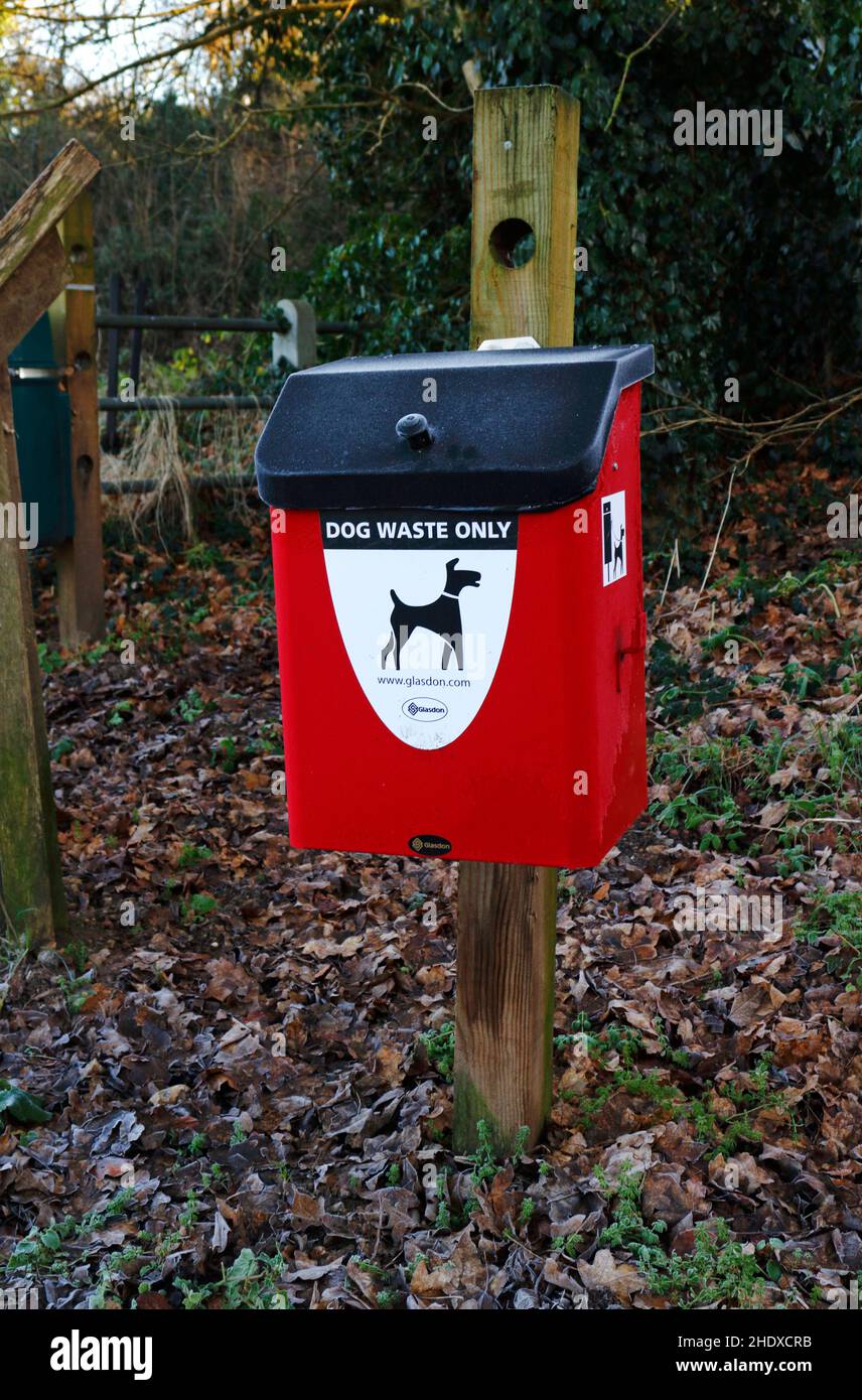 A dog waste bin at the entrance to a riverside walk by the River Wensum in the countryside at Drayton, Norfolk, England, United Kingdom. Stock Photo