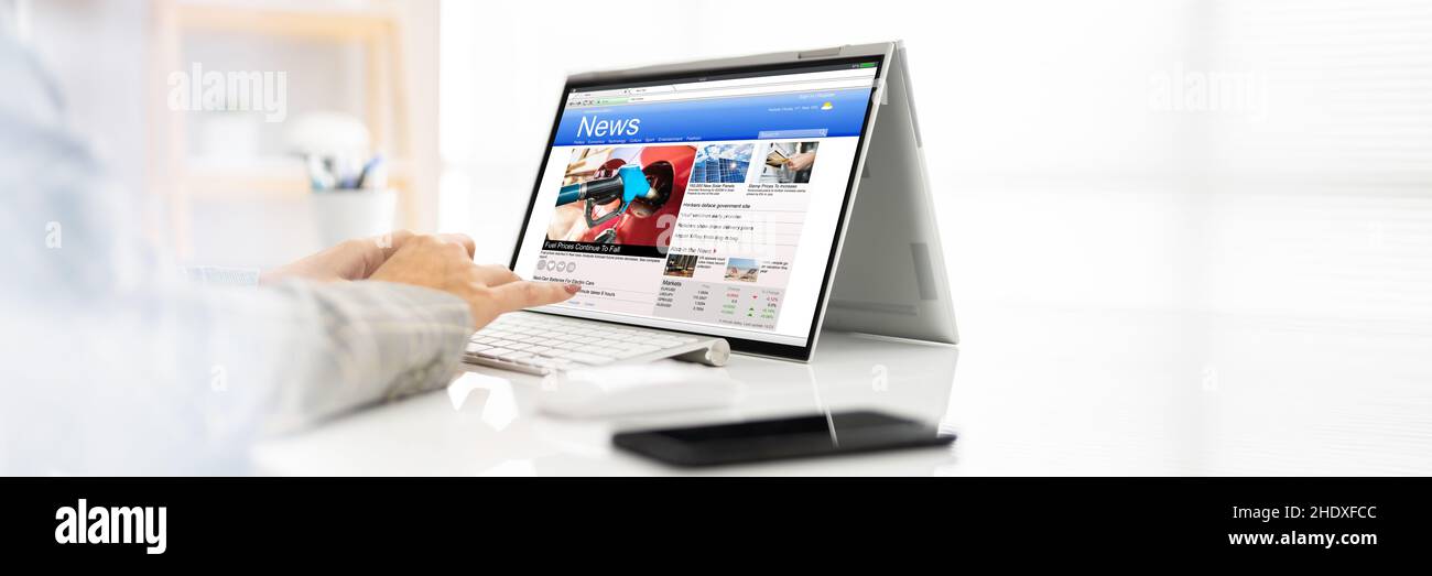 Reading Digital Online Newspaper On Convertible Laptop Stock Photo Alamy