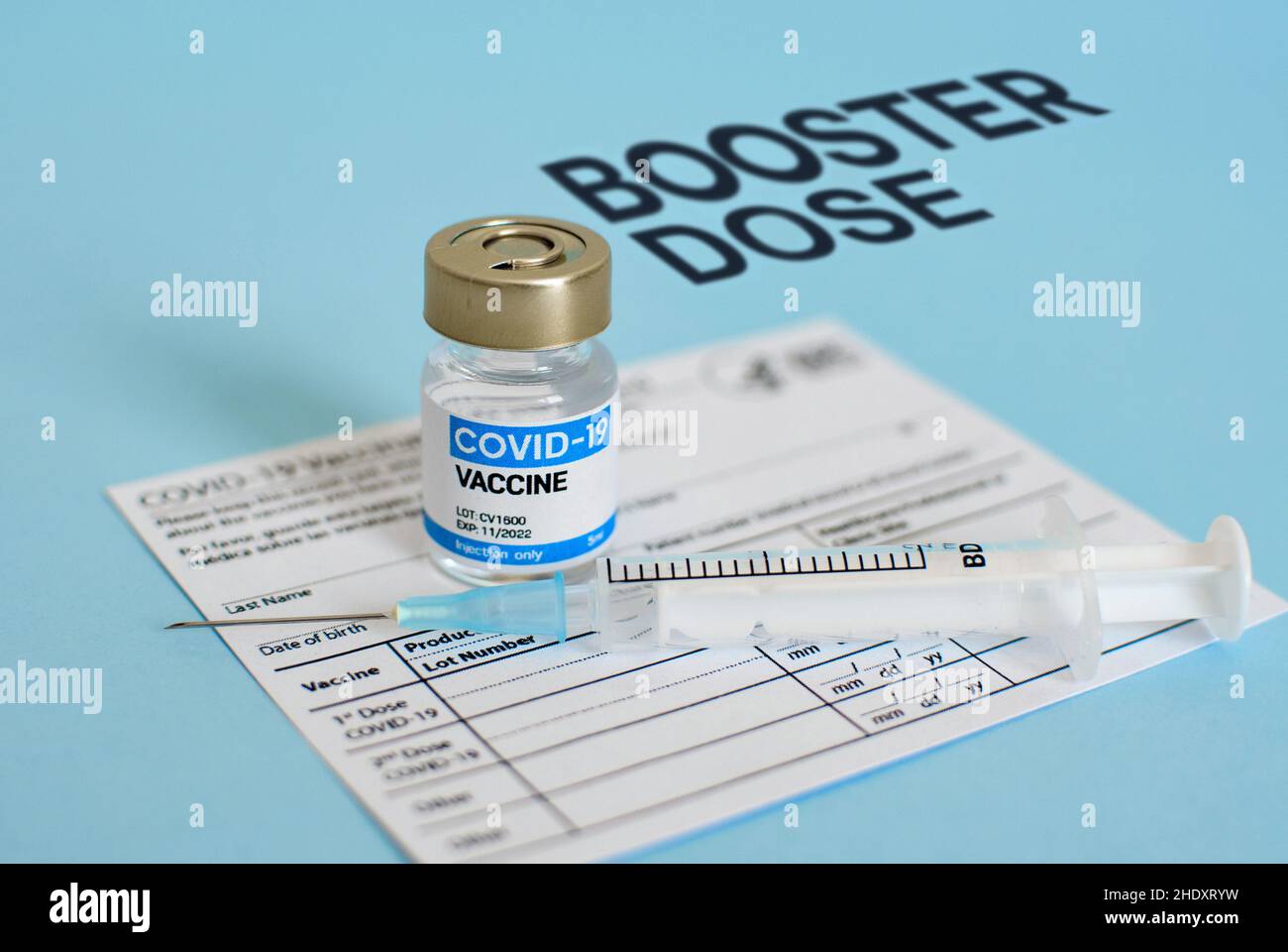 Close-up image of vaccine vial and syringe on CDC covid-19 vaccination record card. Stock Photo
