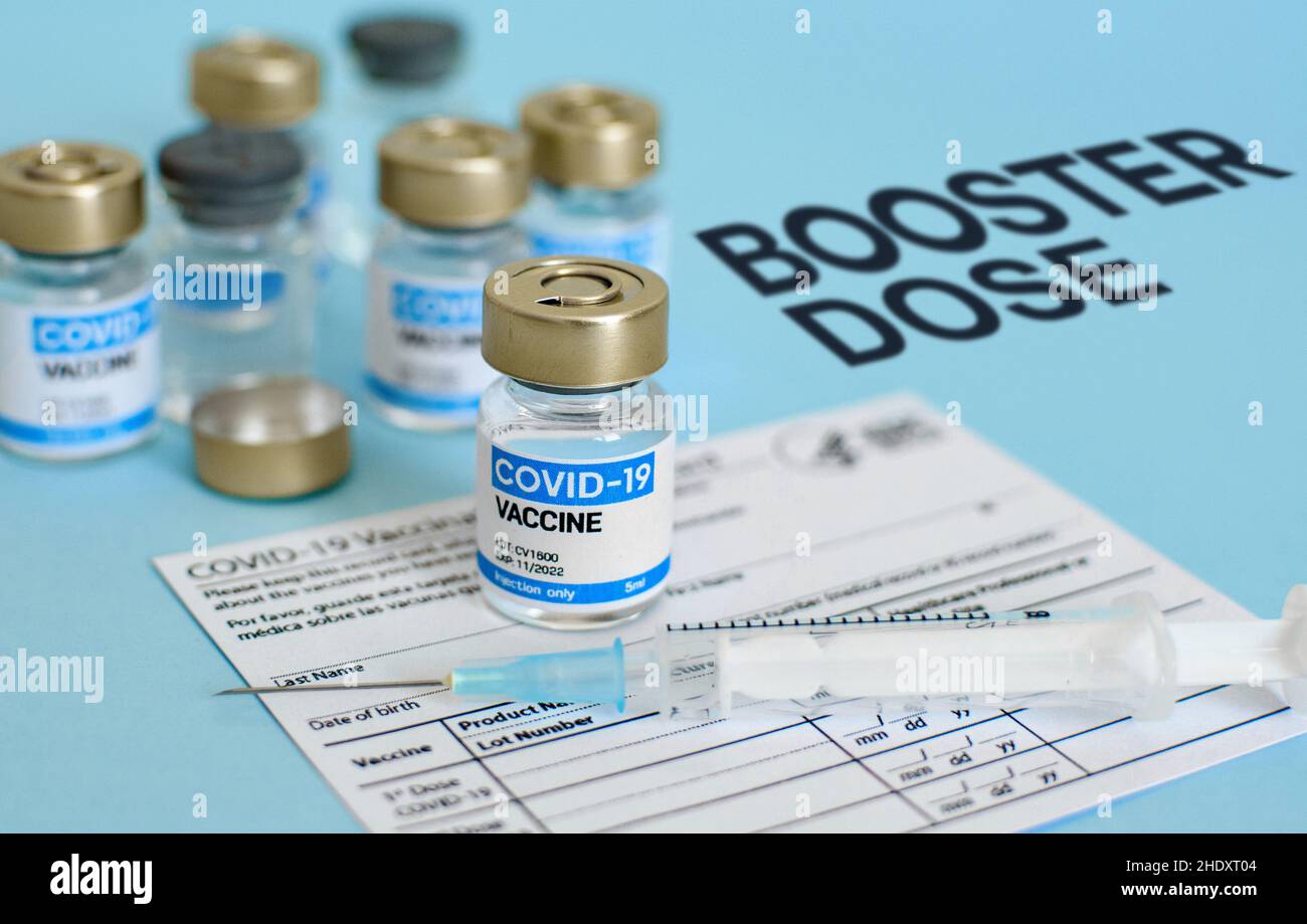 Close-up image of vaccine vial and syringe on CDC covid-19 vaccination record card. Stock Photo