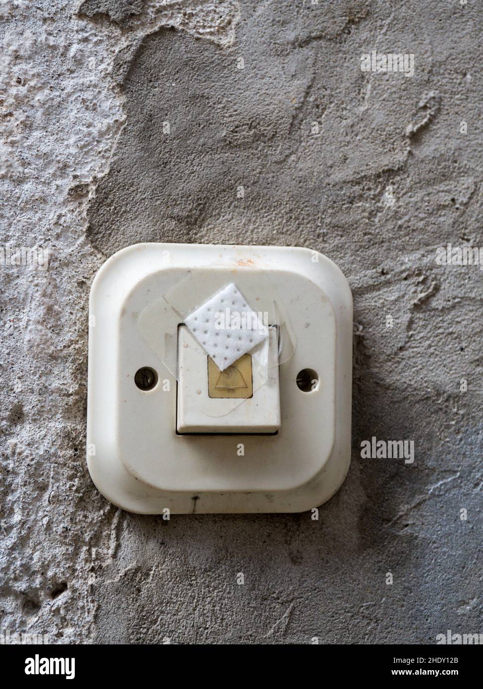 An old bell switch was protected from unauthorized use with adhesive plaster. Stock Photo