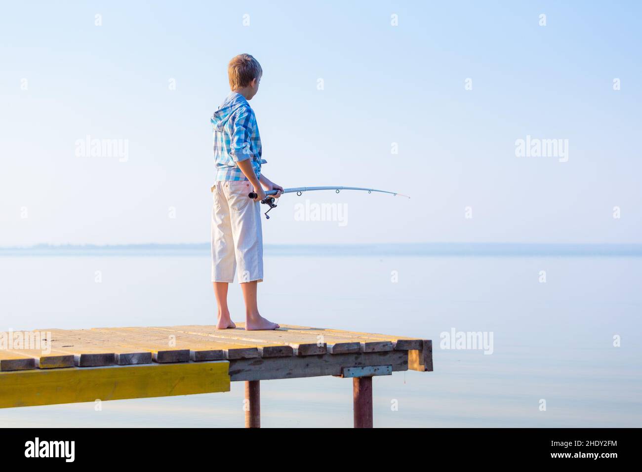 Boy fishing rod holding fish hi-res stock photography and images