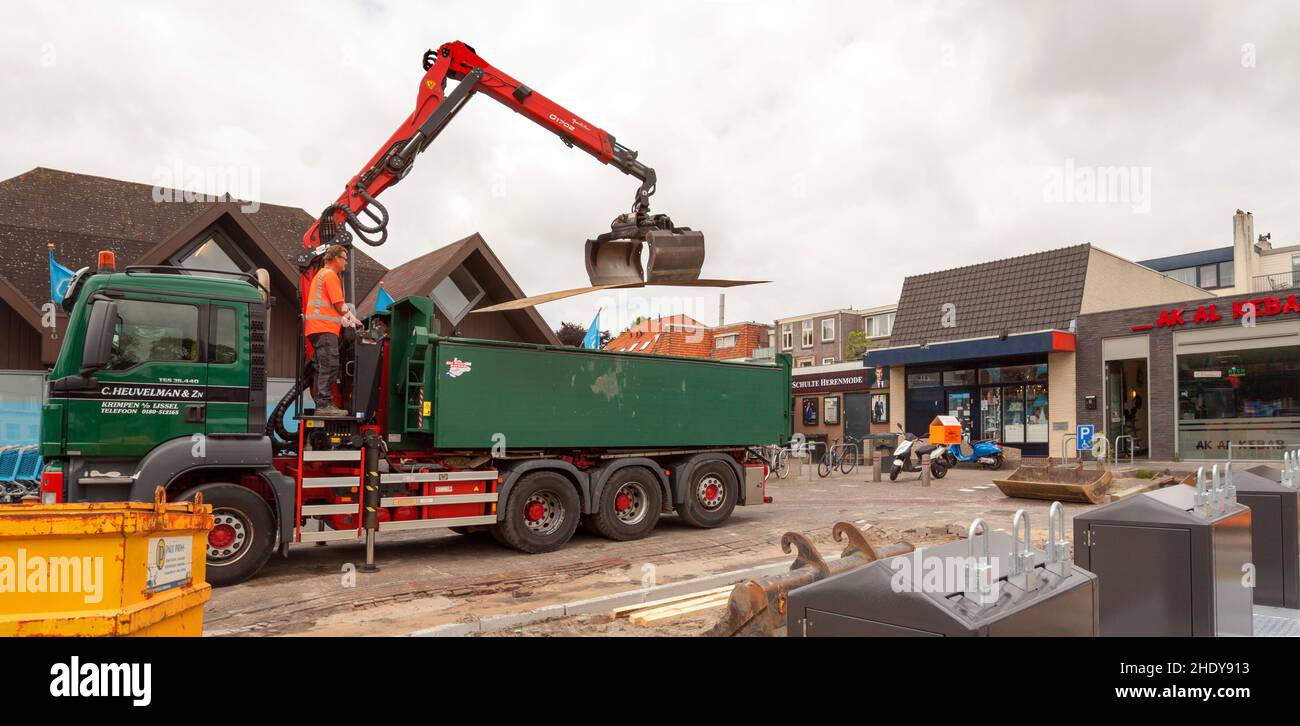 Unloading steel plates for road reconstruction works Stock Photo Alamy