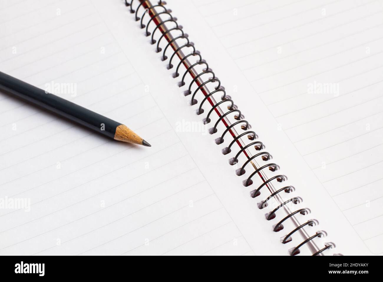 A blank notebook and a pencil in a close up view Stock Photo