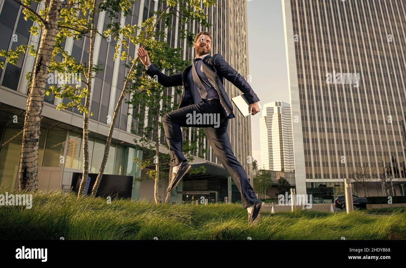 running entrepreneur. agile business. professional network administrator hold computer. Stock Photo