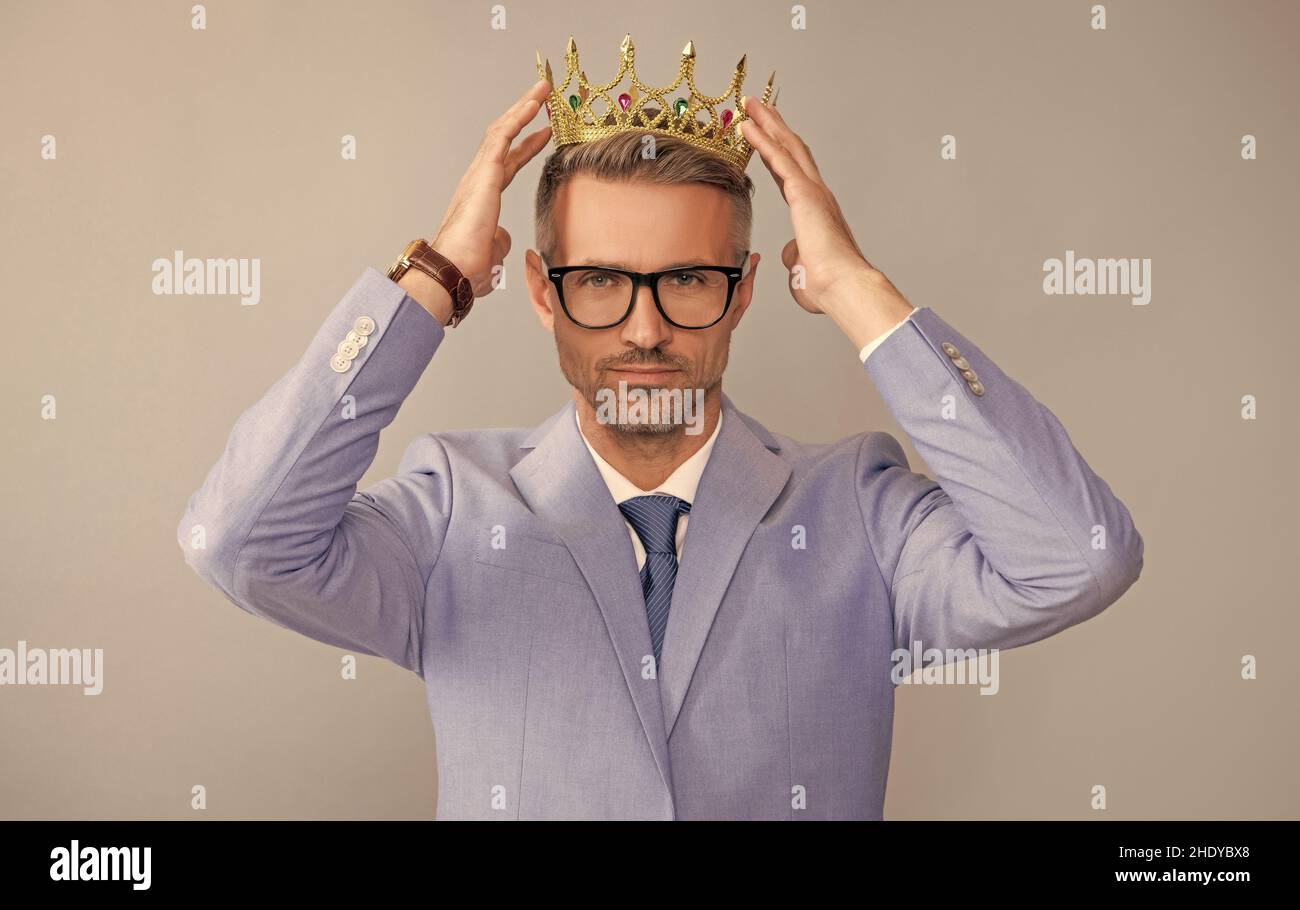 successful arrogant man wear king crown. business success and reward. Stock Photo