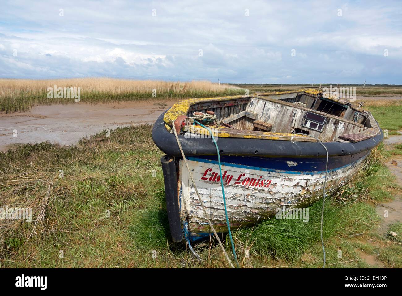 An old wooden boat ("Lady Louisa") at Brancaster Staithe, Norfolk, England. Stock Photo