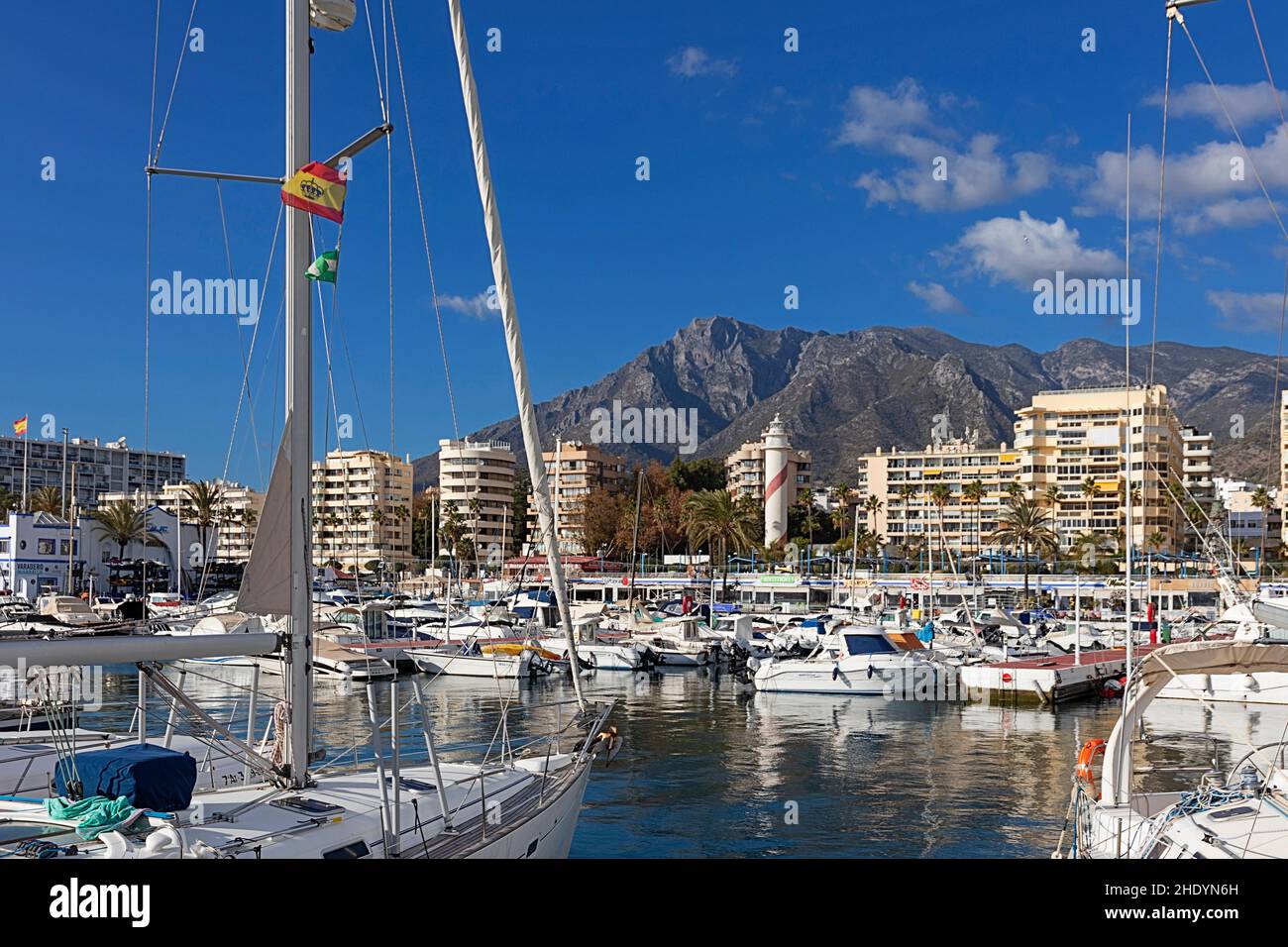 MARBELLA ANDALUCIA SPAIN  HARBOUR THE LIGHTHOUSE AND MOUNTAIN SIERRA BLANCA Stock Photo