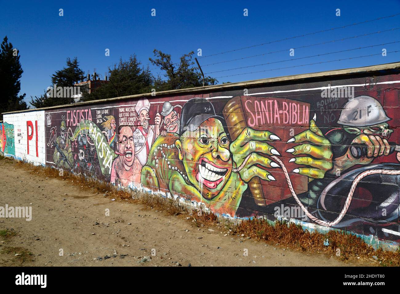 Senkata, El Alto, Bolivia. 13th November 2021. A mural on the wall outside the Senkata Fuel Plant demanding justice for the victims of the Senkata massacre. This took place on 19th November 2019 during violence after the controversial presidential elections of 20th October 2019. Violent clashes between security forces and supporters of ex president Evo Morales (who had resigned on on 10th November) left at least 8 civilians dead. The mural shows both the interim president Jeanine Añez and Interior Minister Arturo Murillo, who were part of the interim government after Morales resigned. Stock Photo