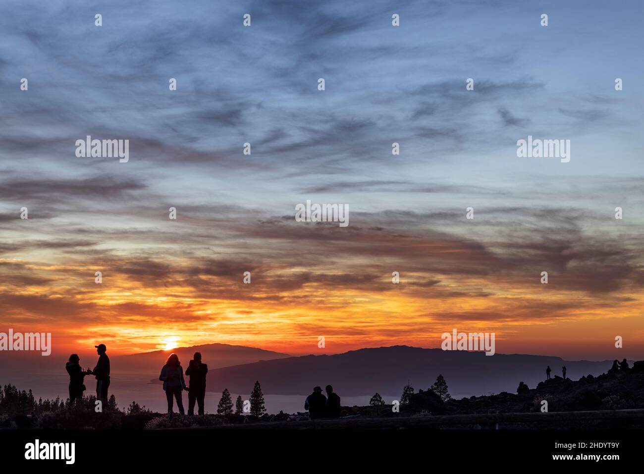 Tourists watching the dramatic sunset behind the islands of El Hierro and La Gomera from Teide National Park, Tenerife, Canary Islands, Spain Stock Photo