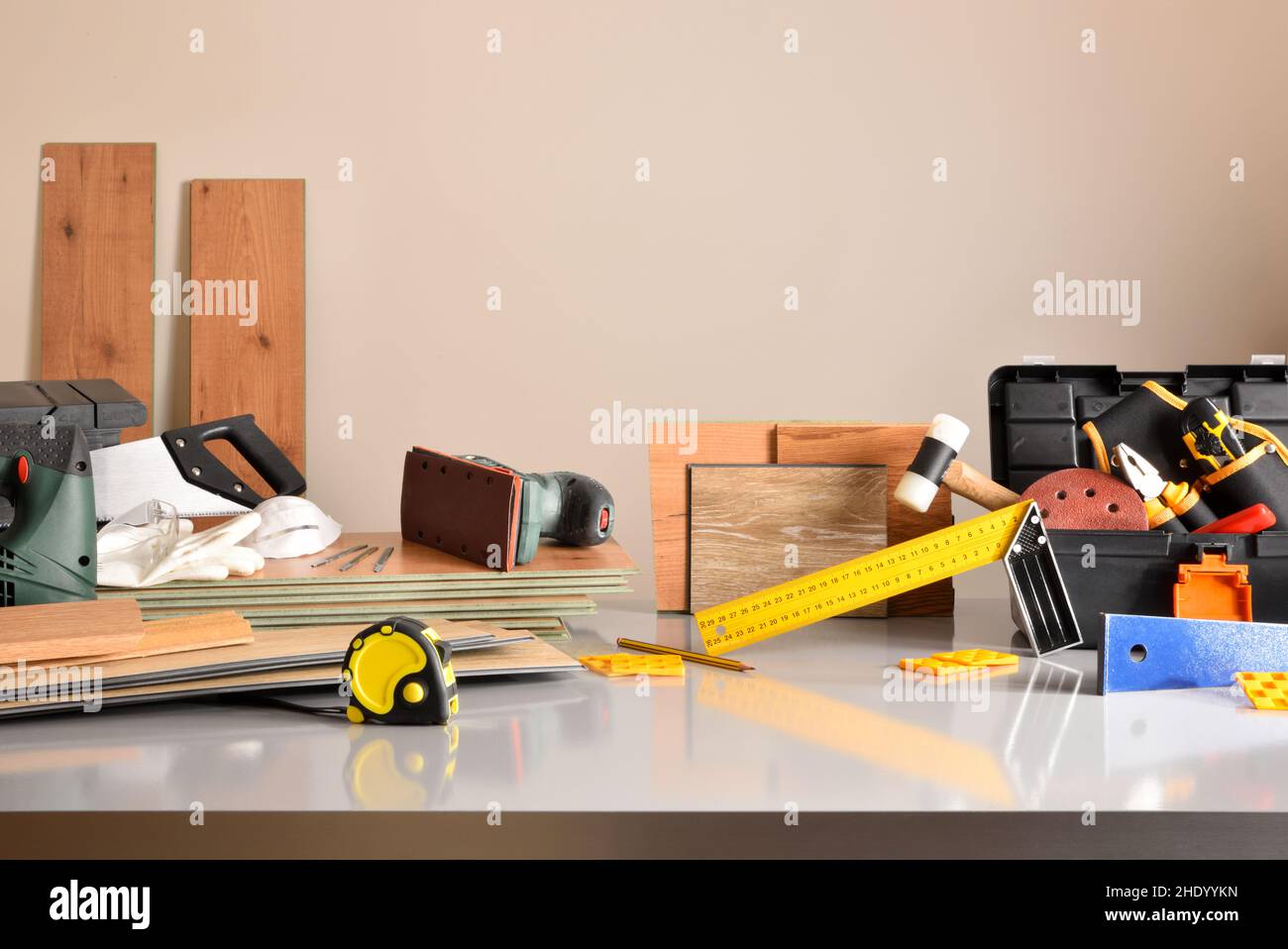 Exhibition of material and tools for the assembly of parquet and wooden pallets on a table in warehouse. Horizontal composition. Stock Photo