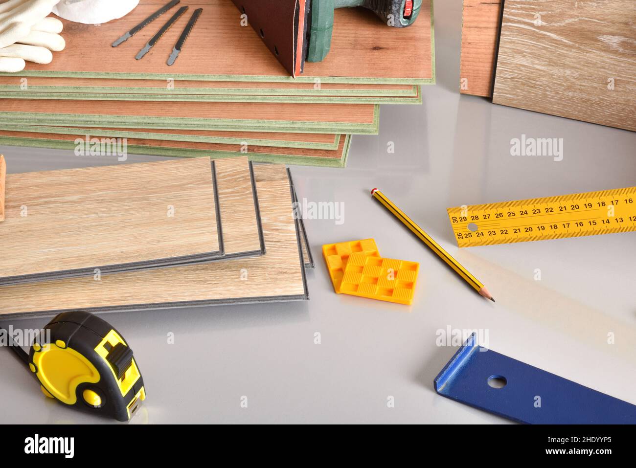 Laminate flooring sheets and tools on gray table. Elevated view. Horizontal composition. Stock Photo