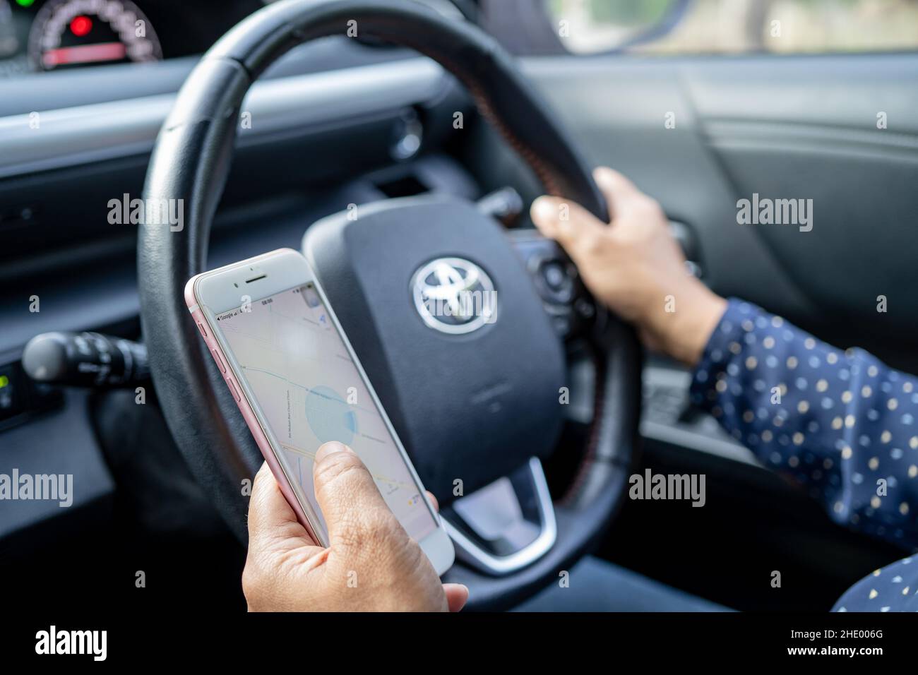 Bangkok, Thailand, July 1, 2021 Holding iPhone in toyota sienta car to communication with family and friends. Stock Photo