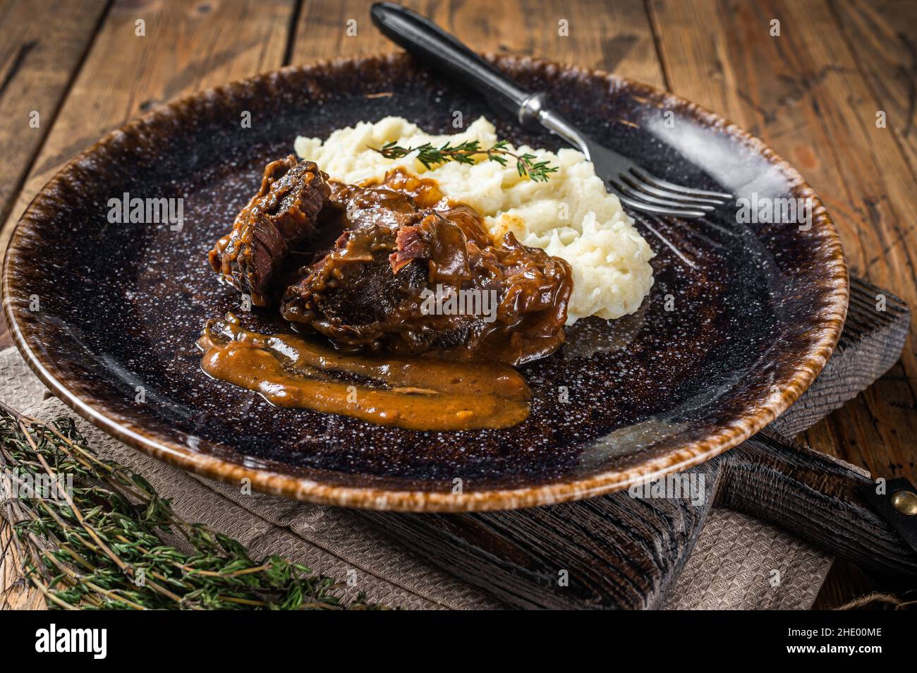 Beef cheeks stewed in red wine sauce with mashed potatoes. Wooden