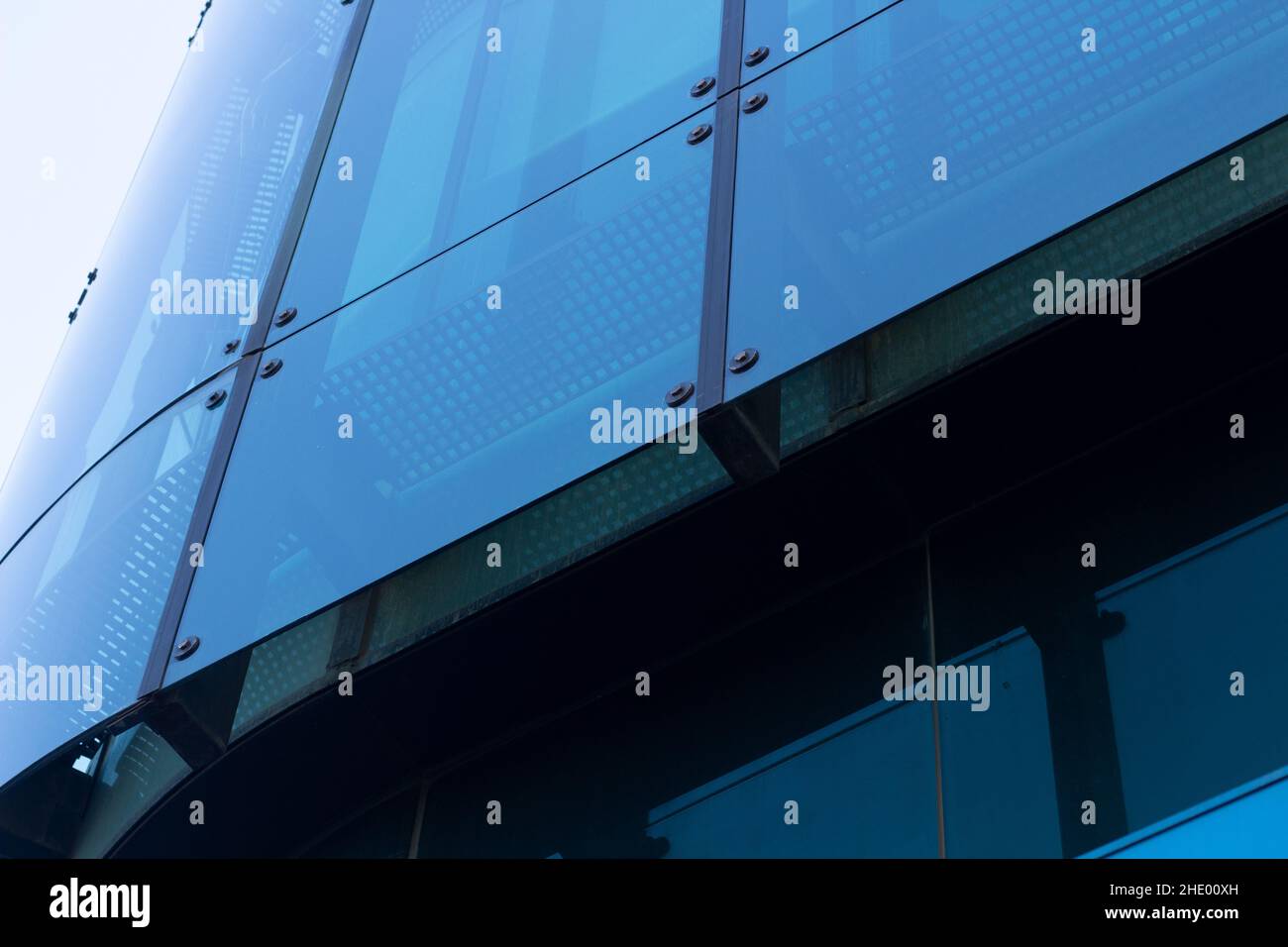 detail of glass joints in geometric façade. Façade glazing joined with