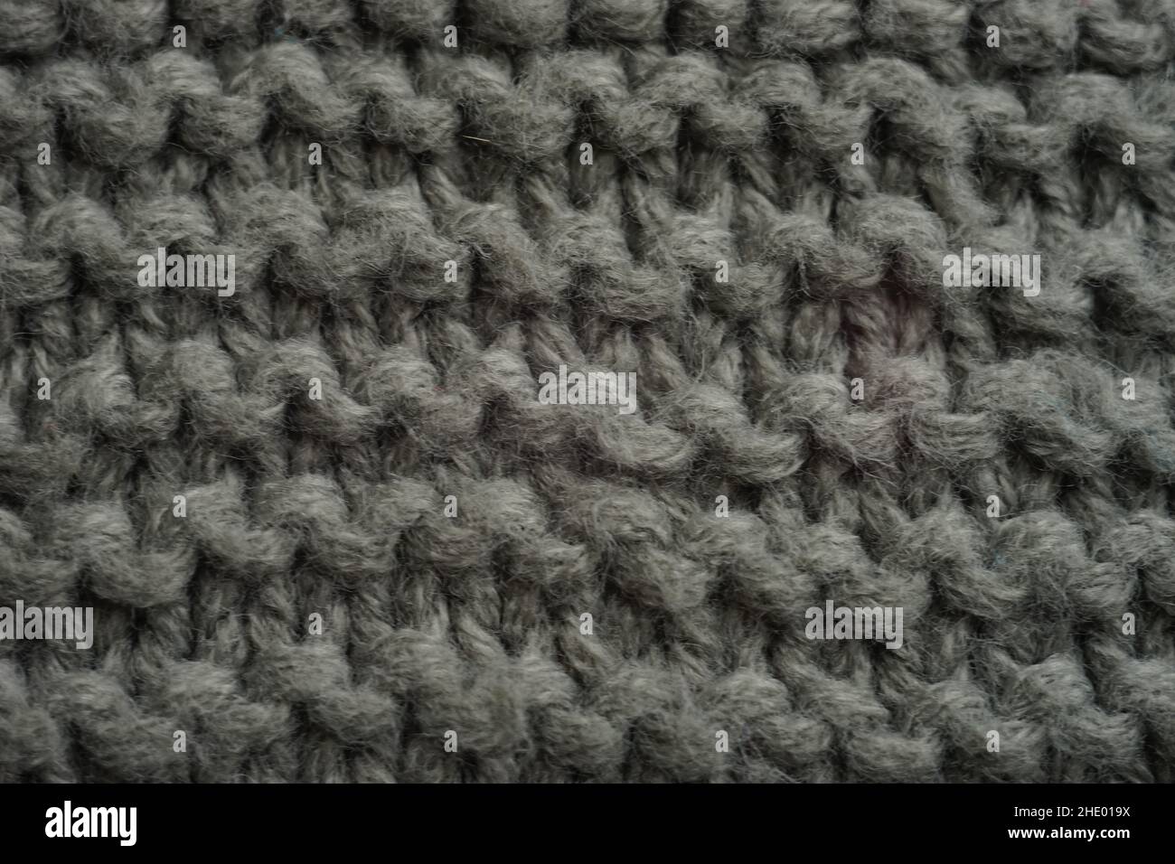 Dark grey knitted background, thread pattern. Stock Photo