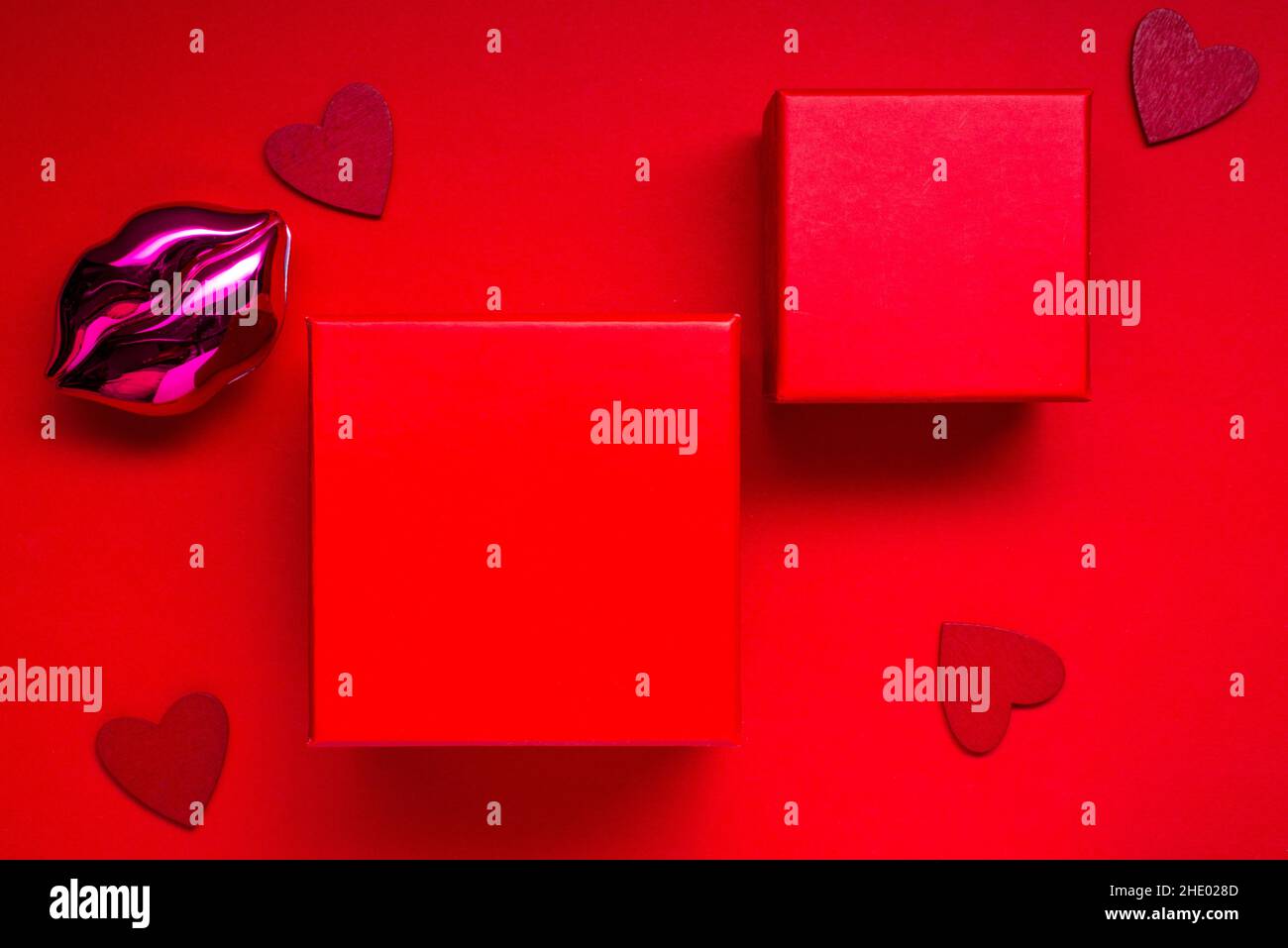 valentines mockup with red boxs or presents on a red background with hearts for your text . Stock Photo