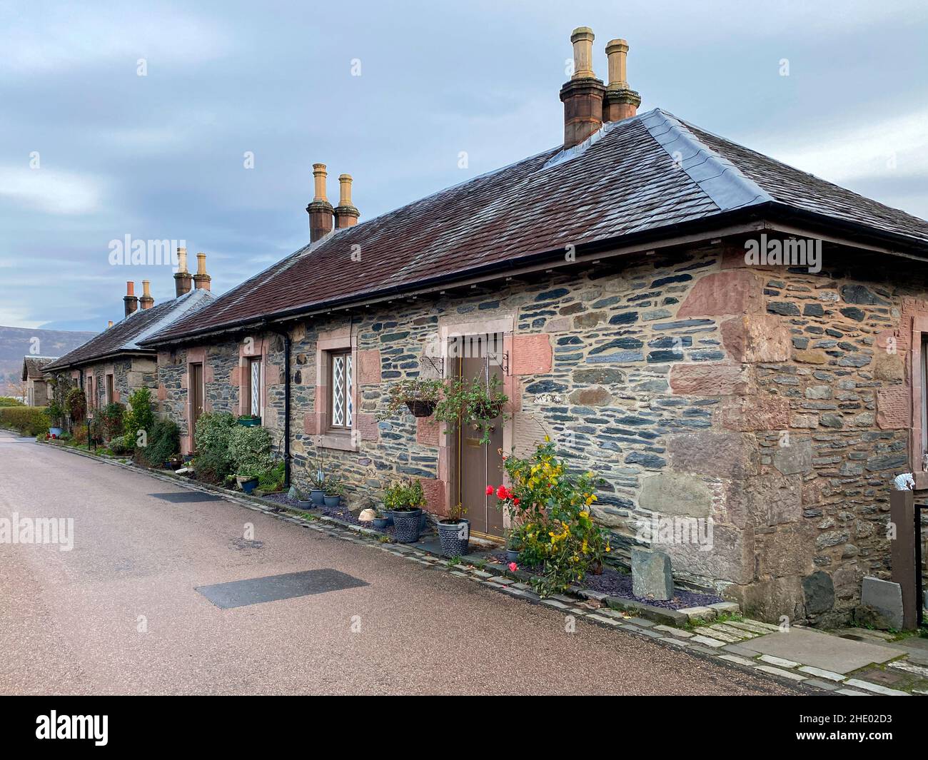 Row of traditional stone cottages at Luss on the shore of Loch Lomond, Scotland. Stock Photo