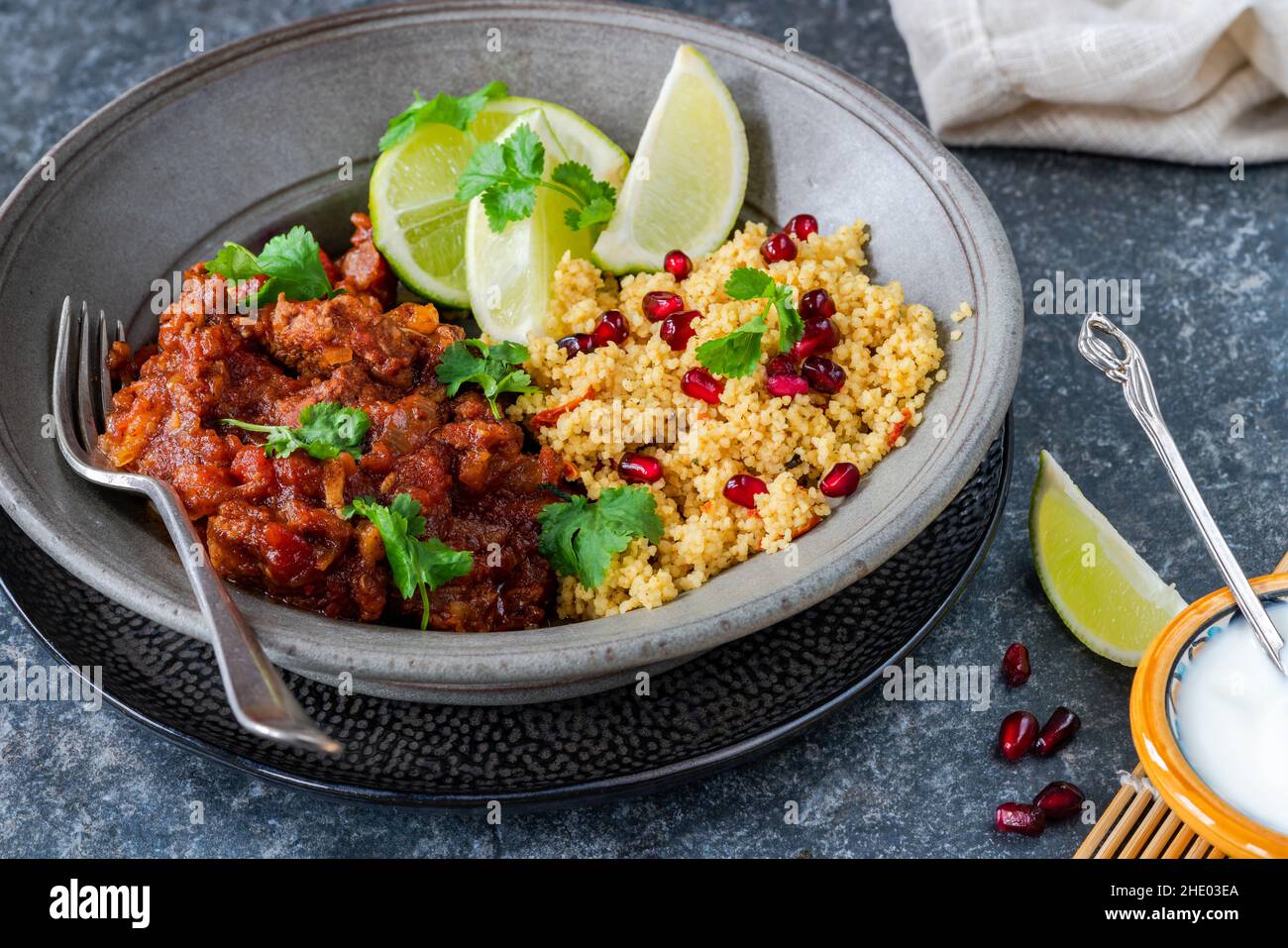 Moroccan lamb tagine with lemon and pomegranate couscous Stock Photo