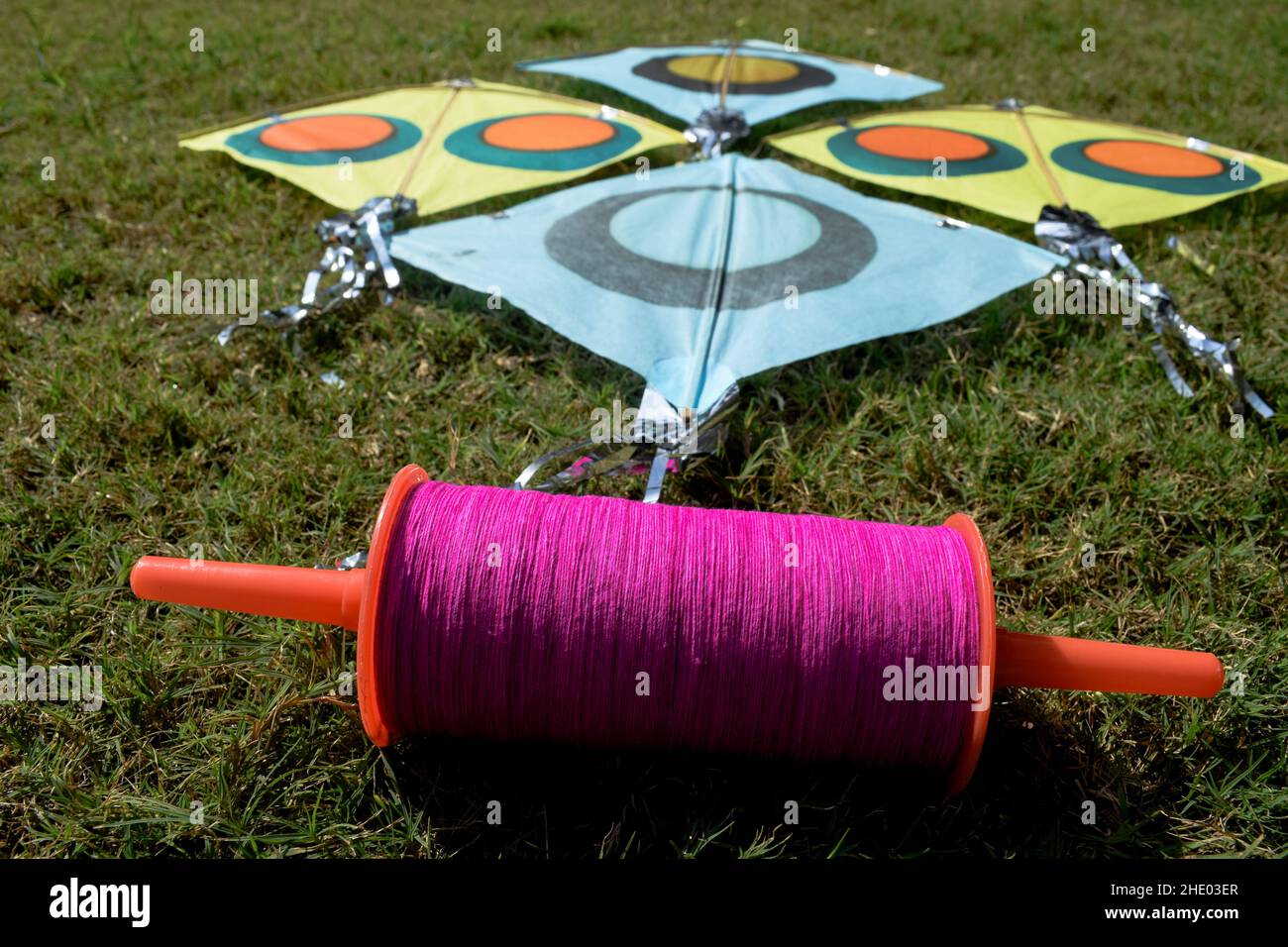 Selective focus of pink Spool thread phirfi.Sankranti kites patang flying outdoors. Colorful kites during kite festival. Makar sankranti festival cele Stock Photo