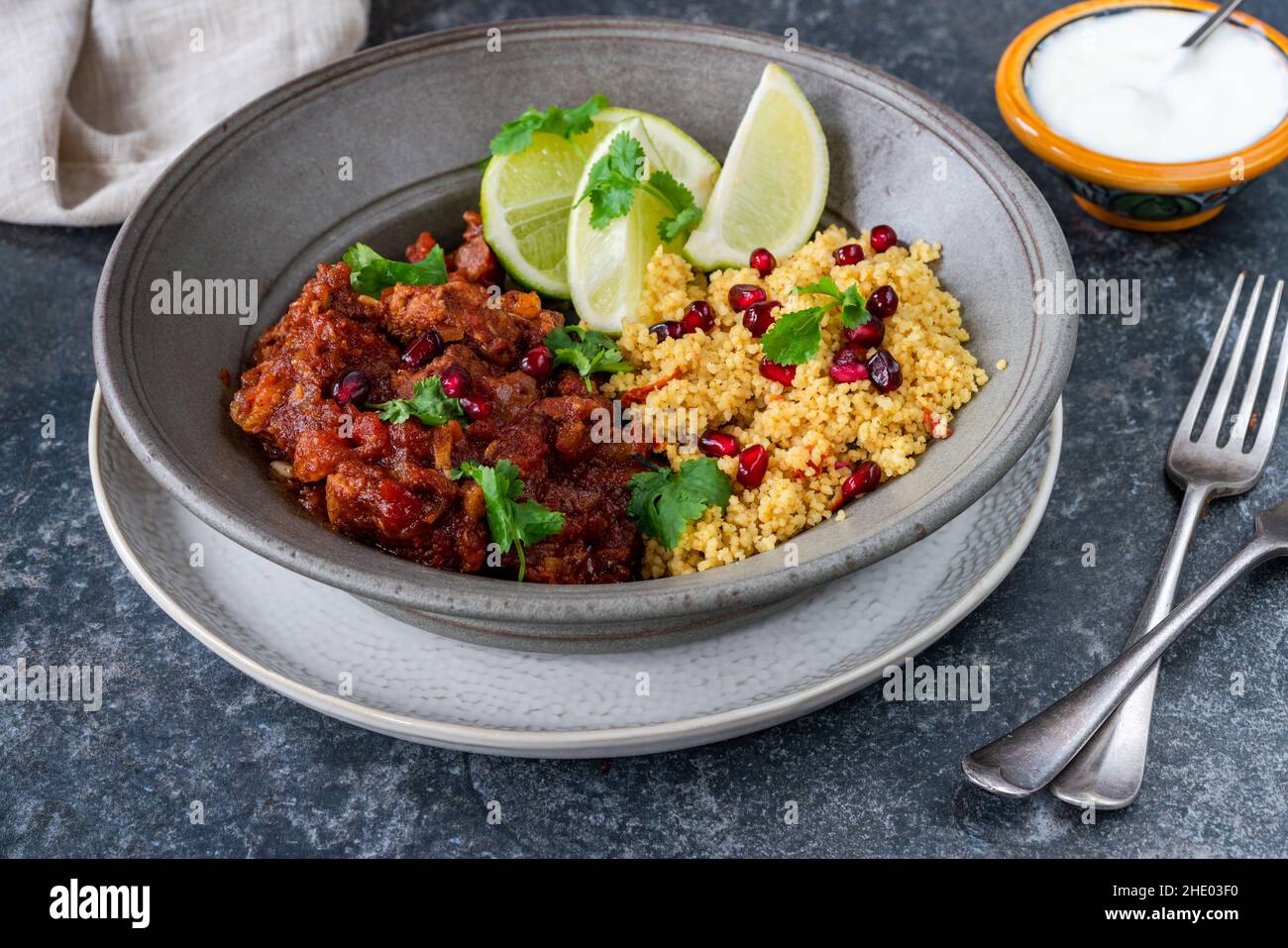 Moroccan lamb tagine with lemon and pomegranate couscous Stock Photo