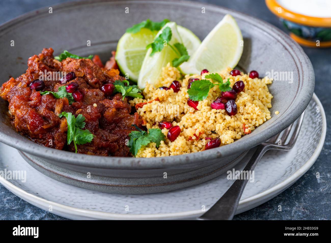 Moroccan lamb tagine with lemon and pomegranate couscous Stock Photo