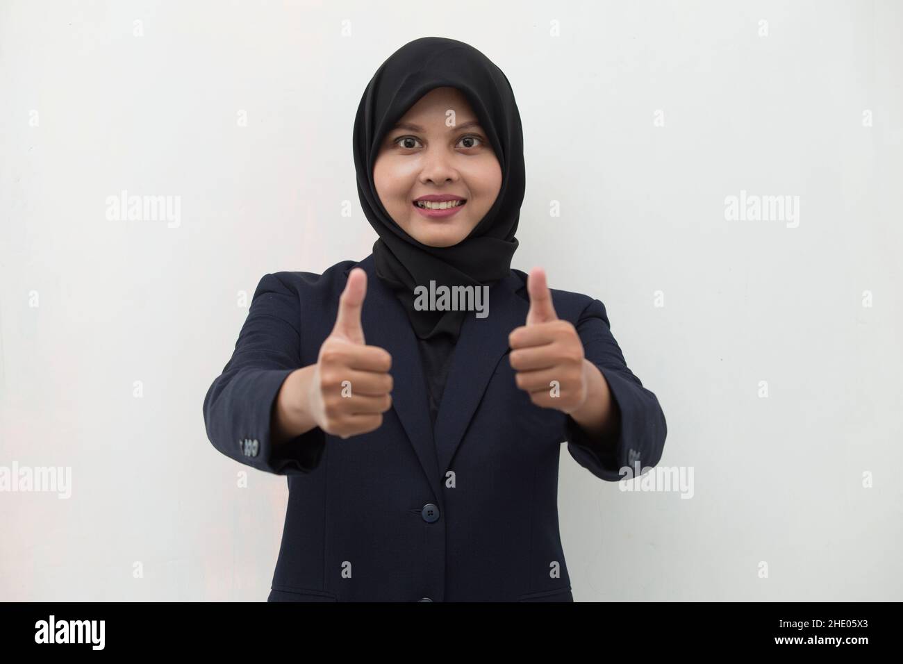 Young asian muslim woman smiling and making OK sign with hand gesture Stock Photo Alamy