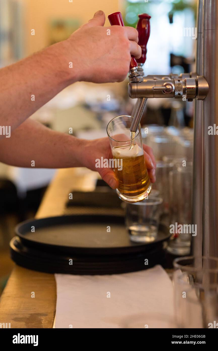 A fresh beer is tapped in a restaurant. Stock Photo