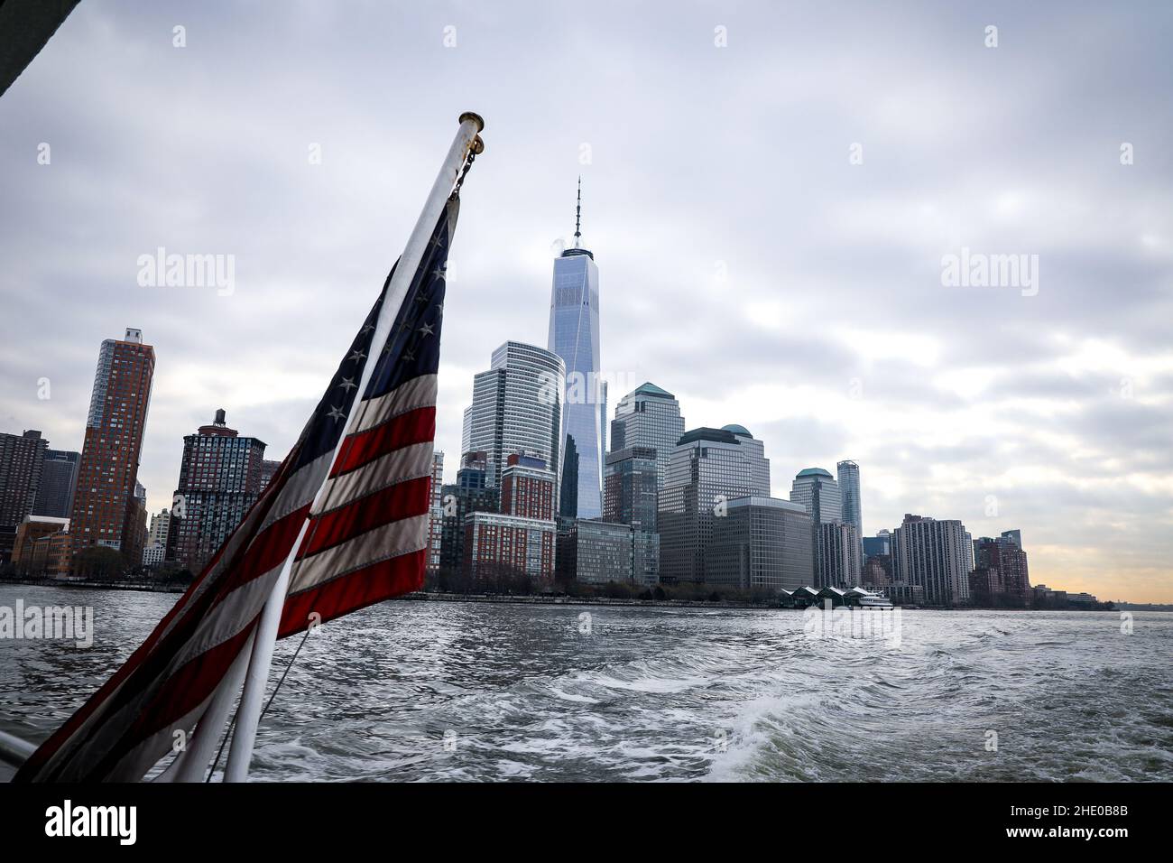 USA flag fluttering on wind against the New York City Stock Photo
