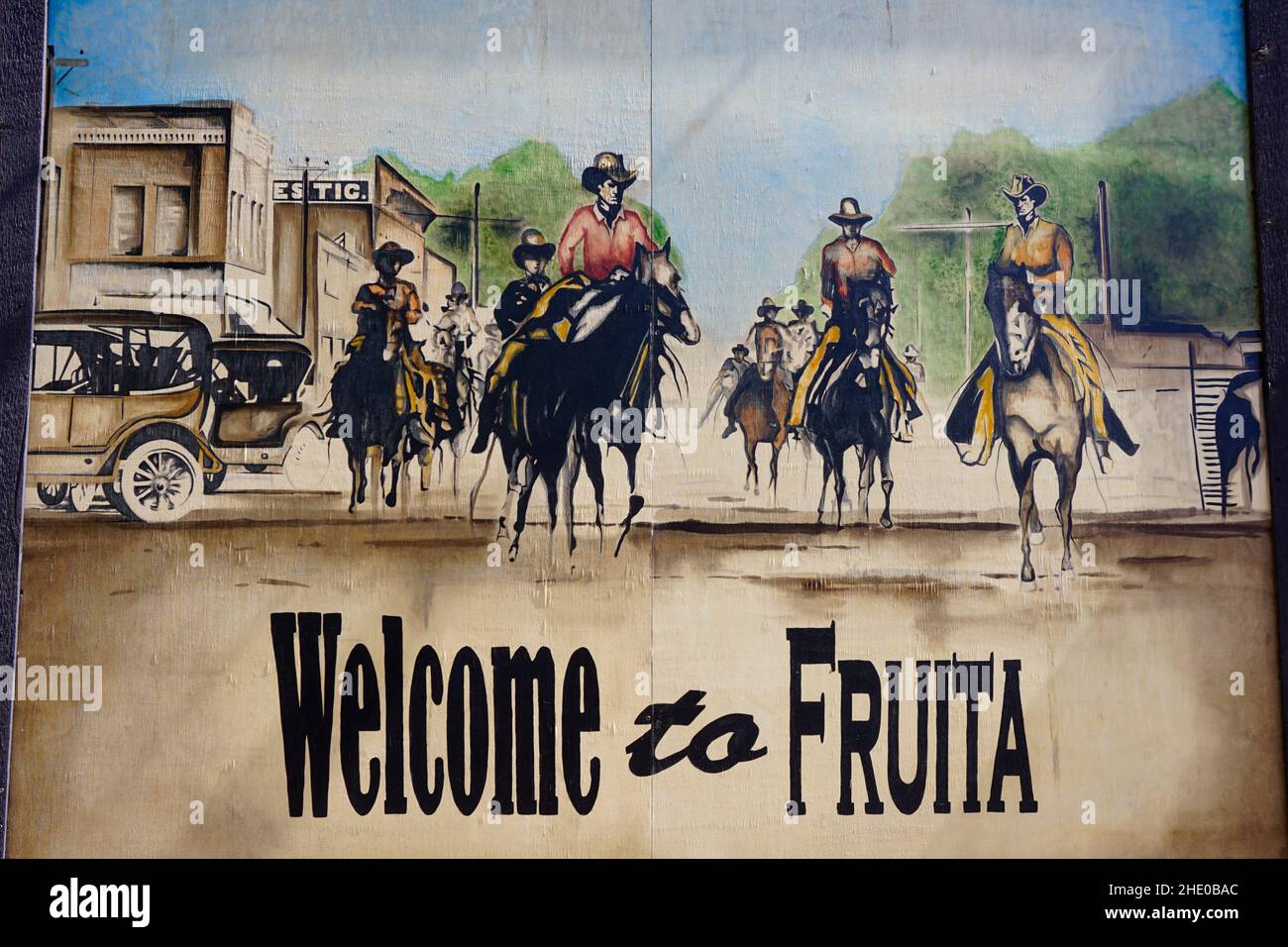 Painting on the side of building in downtown Fruita, CO that says welcome to Fruita. Stock Photo