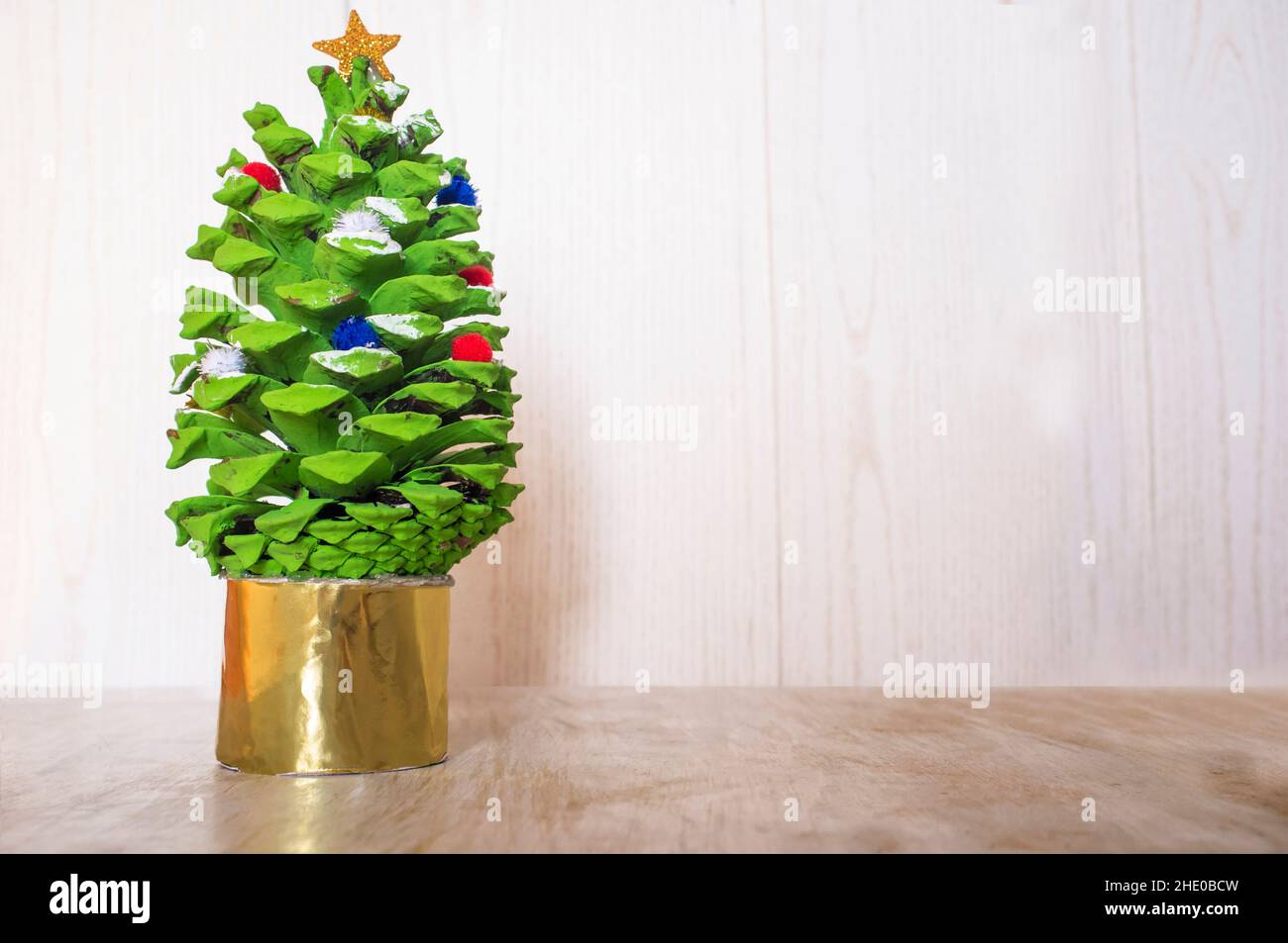 Christmas tree made with painted pine cone. Christmas crafts made with nature parts Stock Photo