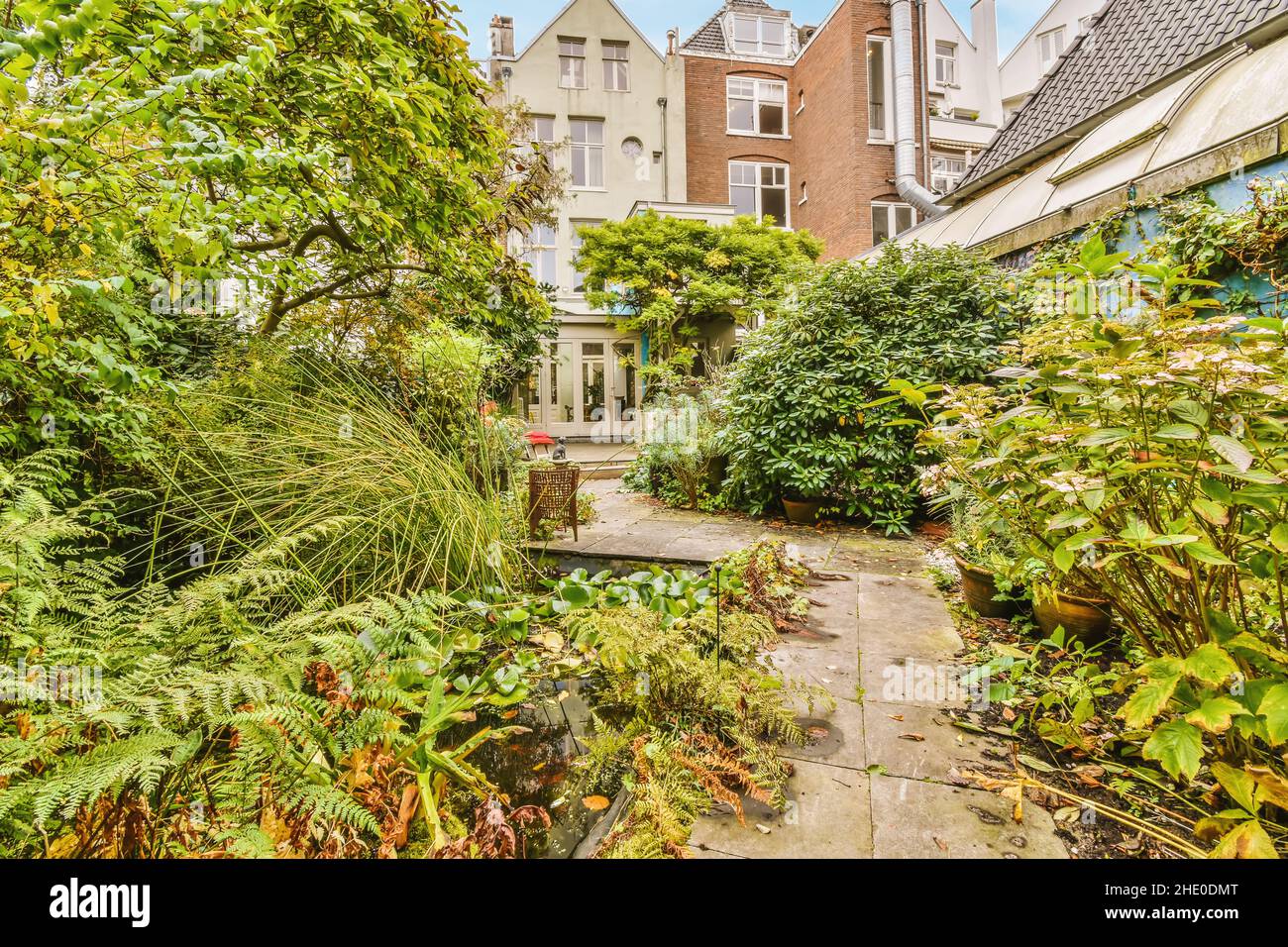 Cozy courtyard of a house with green trees and bushes Stock Photo - Alamy
