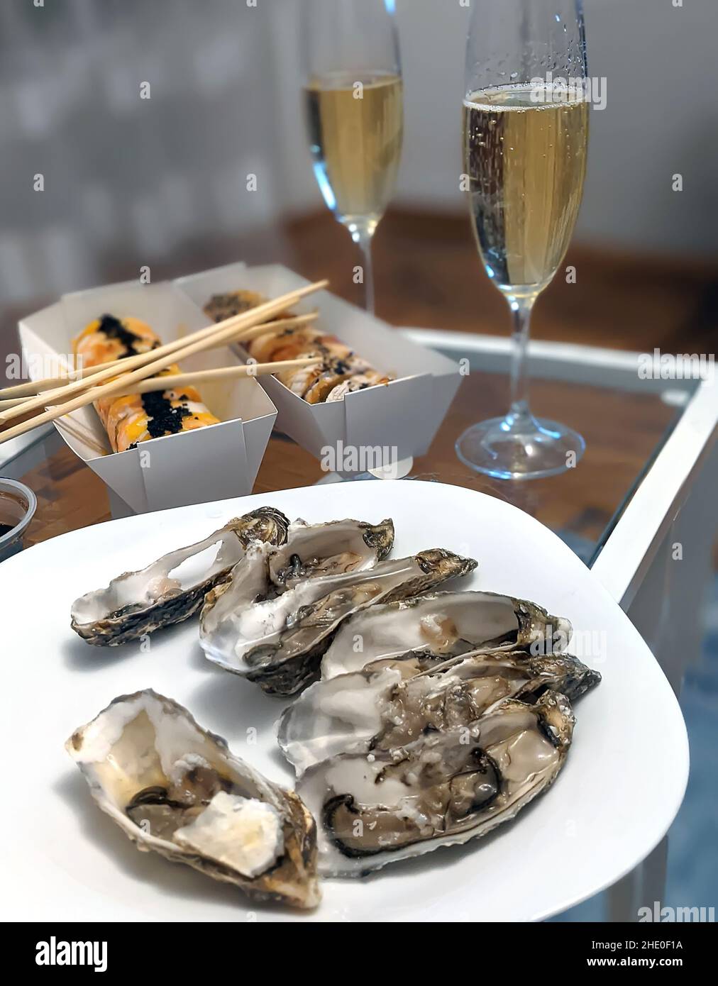 Romantic dinner for a couple, fresh oysters, champagne and sushi Stock Photo