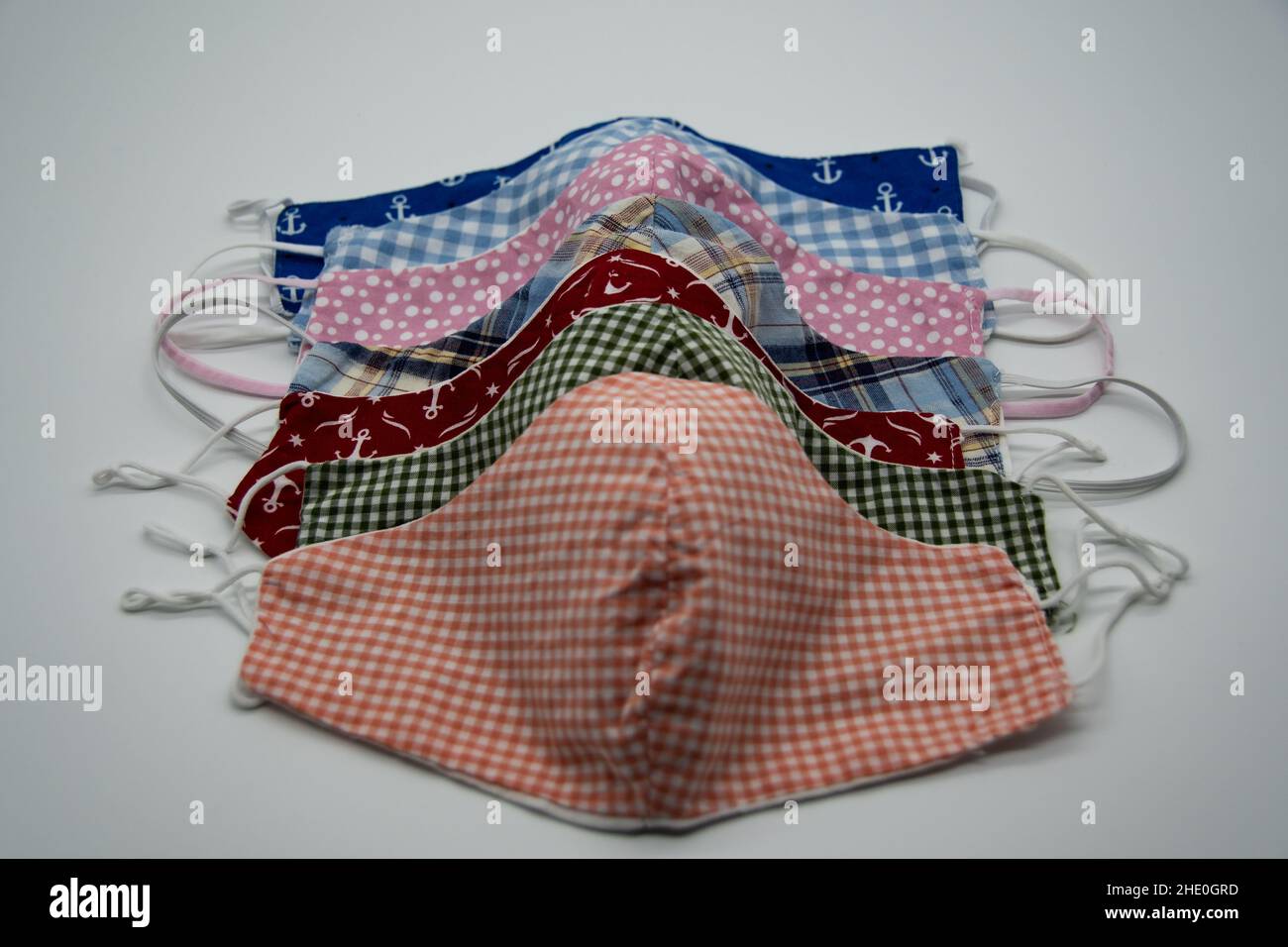 Self-sewn cloth masks to prevent the corona virus on a light background Stock Photo