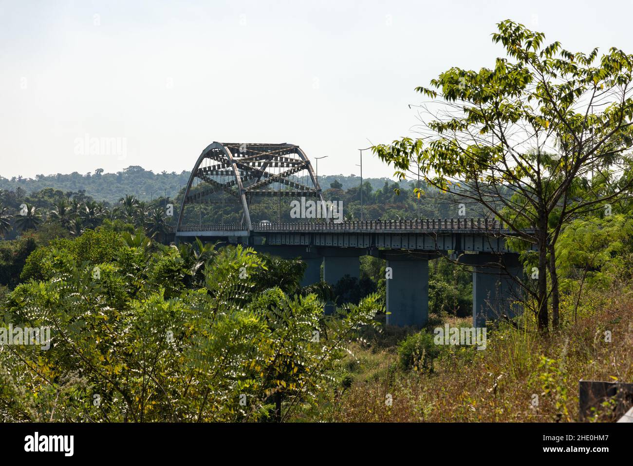 View of the tied steel arch Gandaulim - Marcel Bridge over Cumbarjua Canal in Gandaulim, Goa, India. Stock Photo