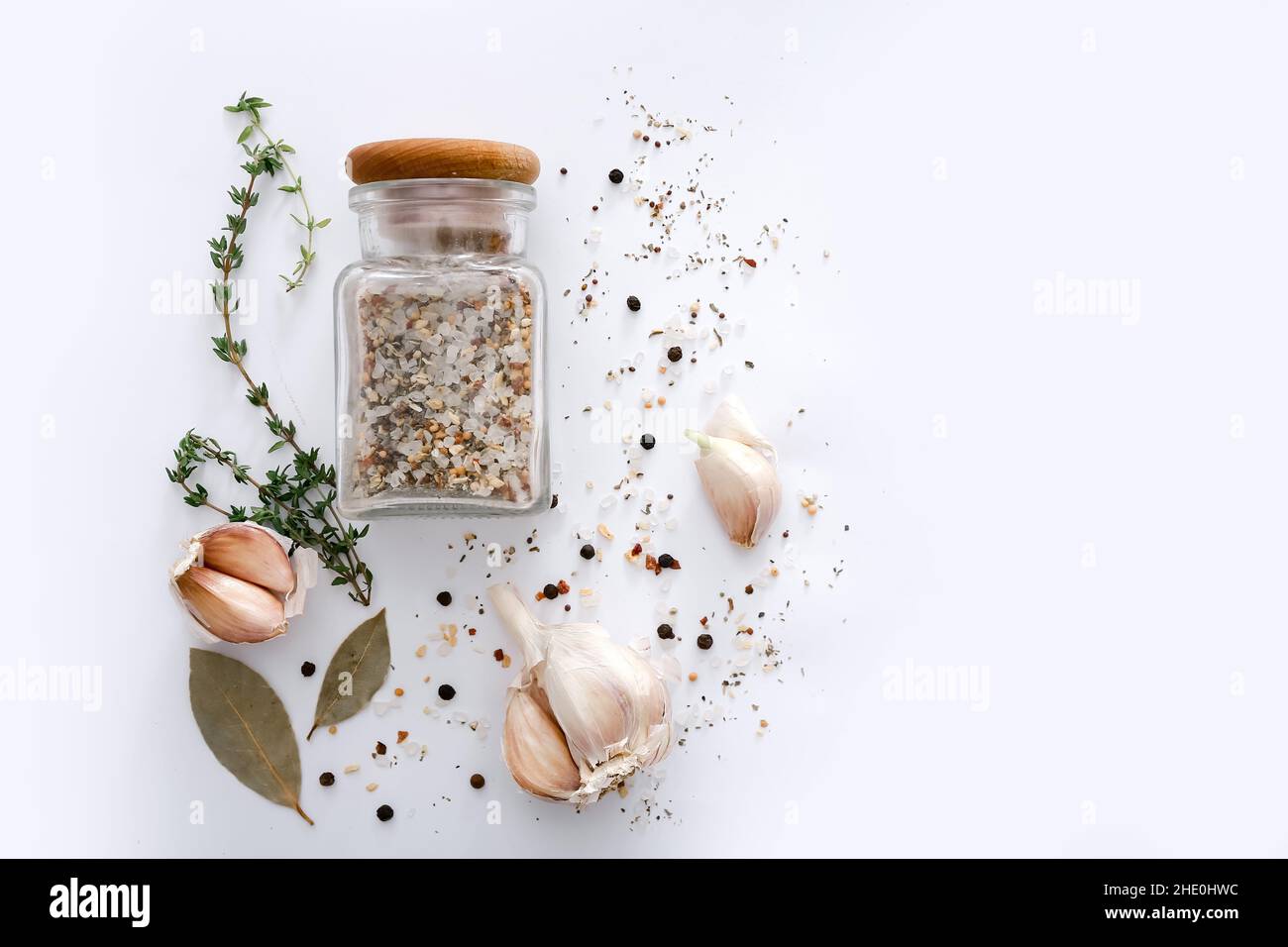 Different spices and garlic on light grey background, top view. Stock Photo