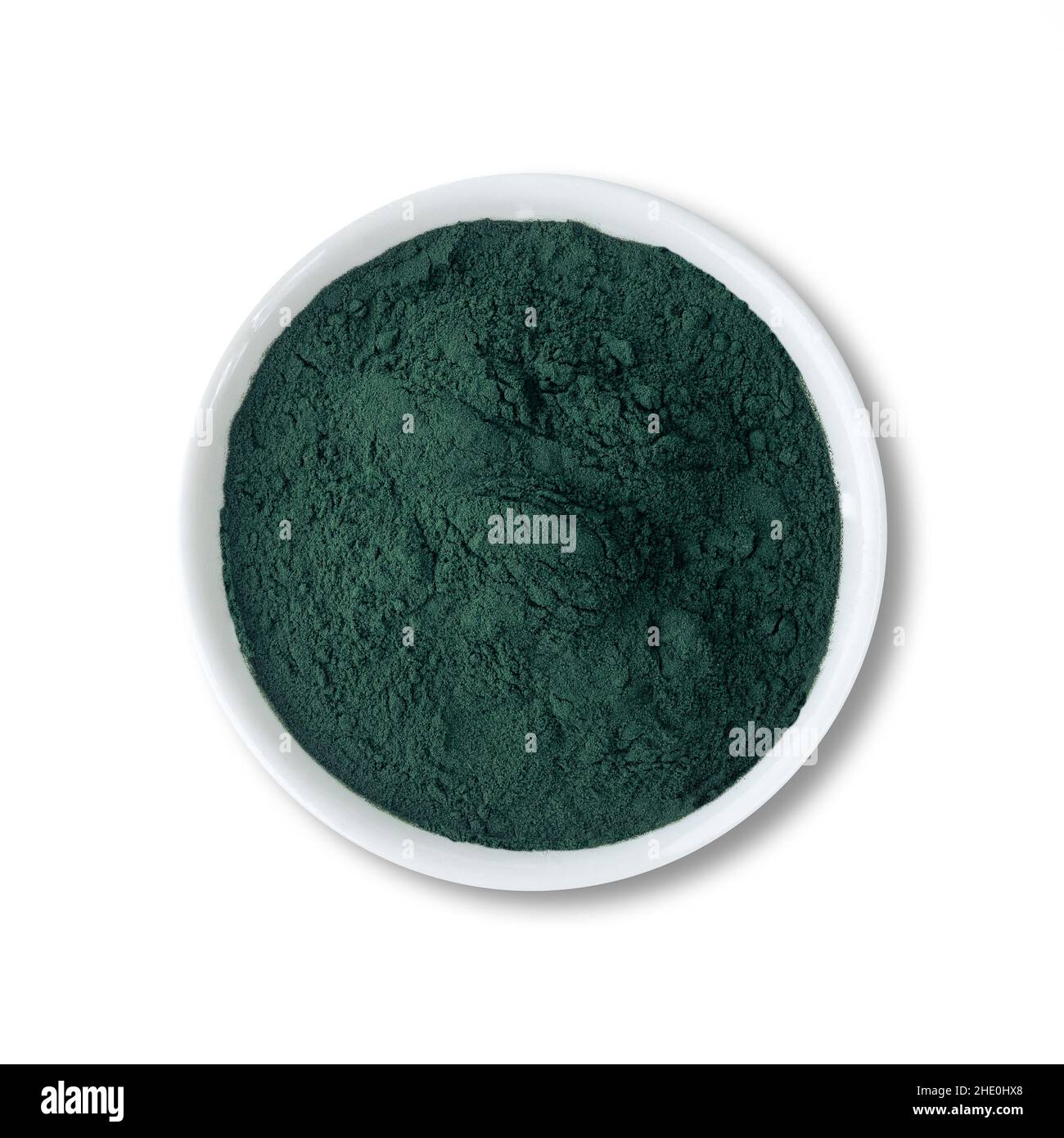 Spirulina algae powder in a bowl isolated over white background Stock ...