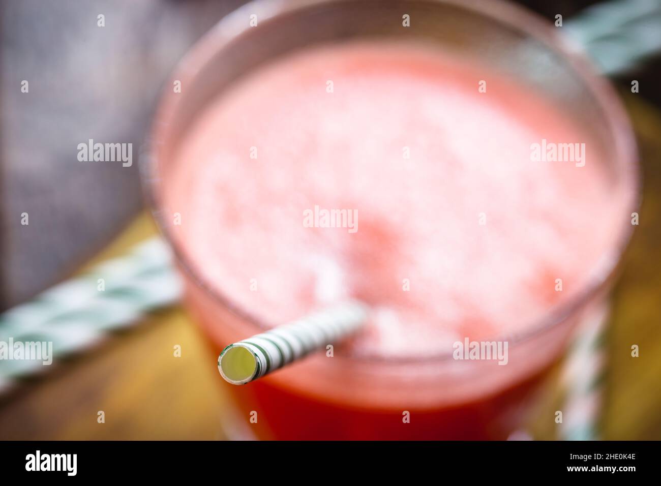 Biodegradable reinforced paper straw, spot focus. Ecologically friendly organic juice drink Stock Photo