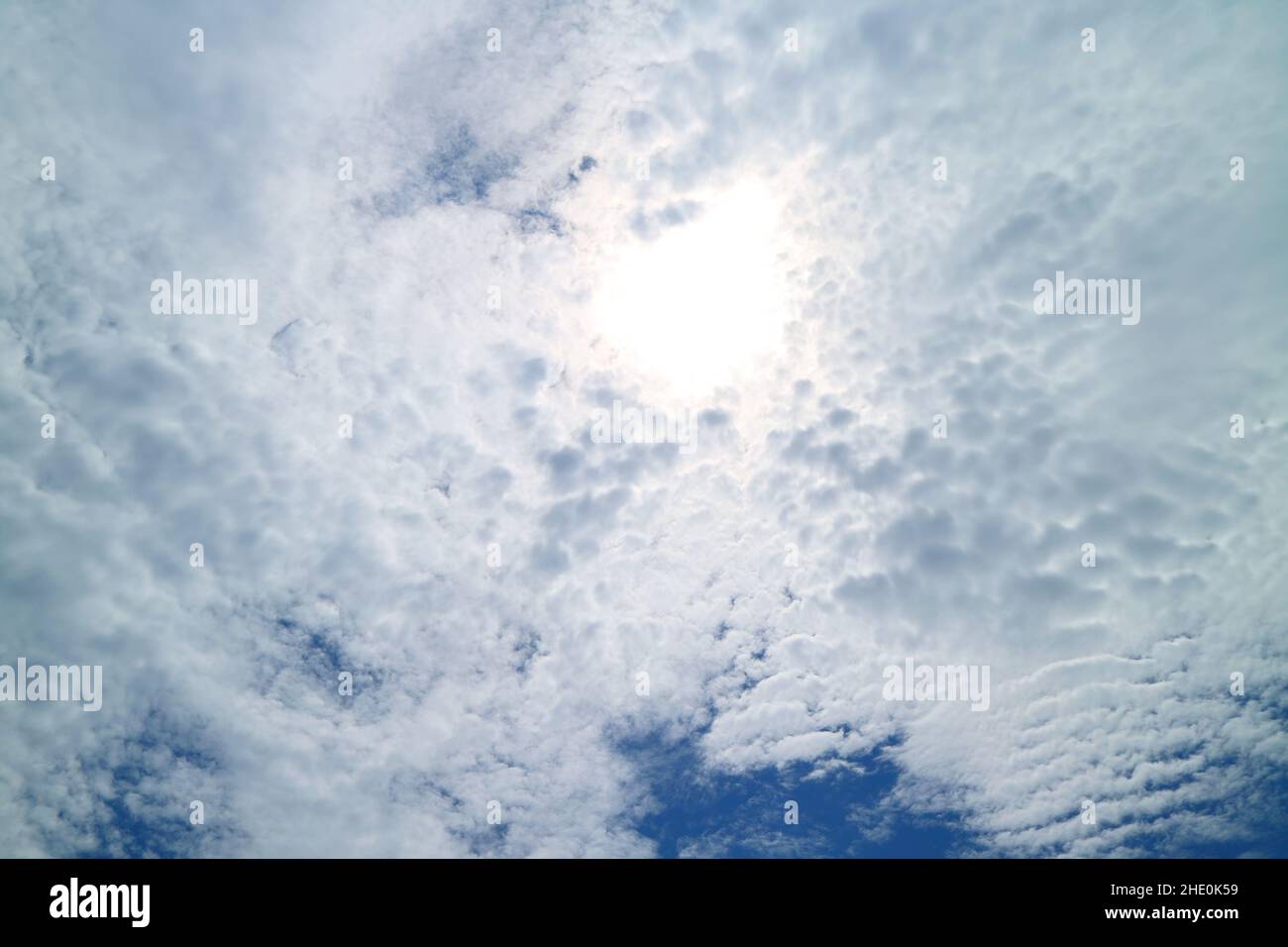 Bright Sunbeam Shining Among Fluffy Altocumulus Clouds Stock Photo