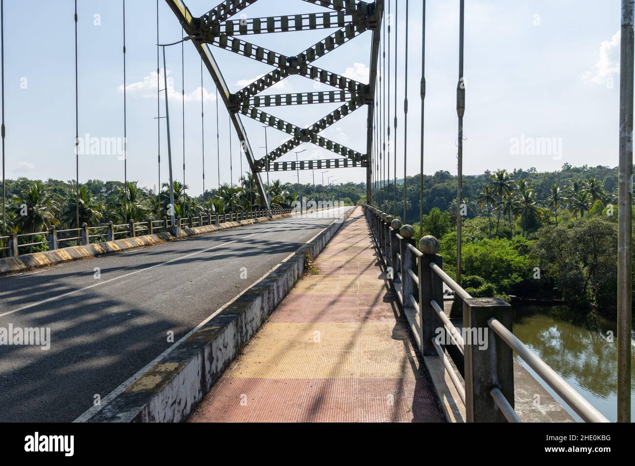 View of the tied steel arch Gandaulim - Marcel Bridge over Cumbarjua Canal in Gandaulim, Goa, India. Stock Photo