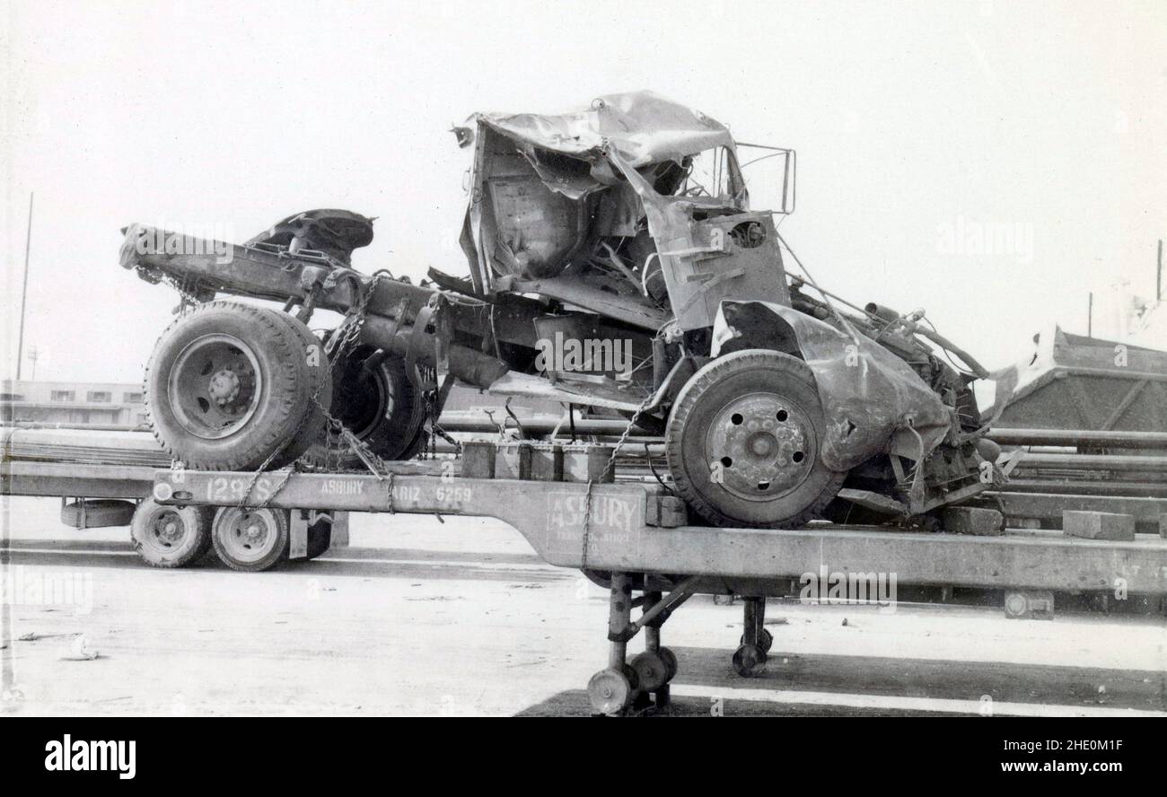 Antique circa 1950 photograph, wrecked pickup truck on the flatbed trailer of Asbury Transportation Co. Exact location unknown, near Bakersfield, California, USA. SOURCE: ORIGINAL PHOTOGRAPH Stock Photo