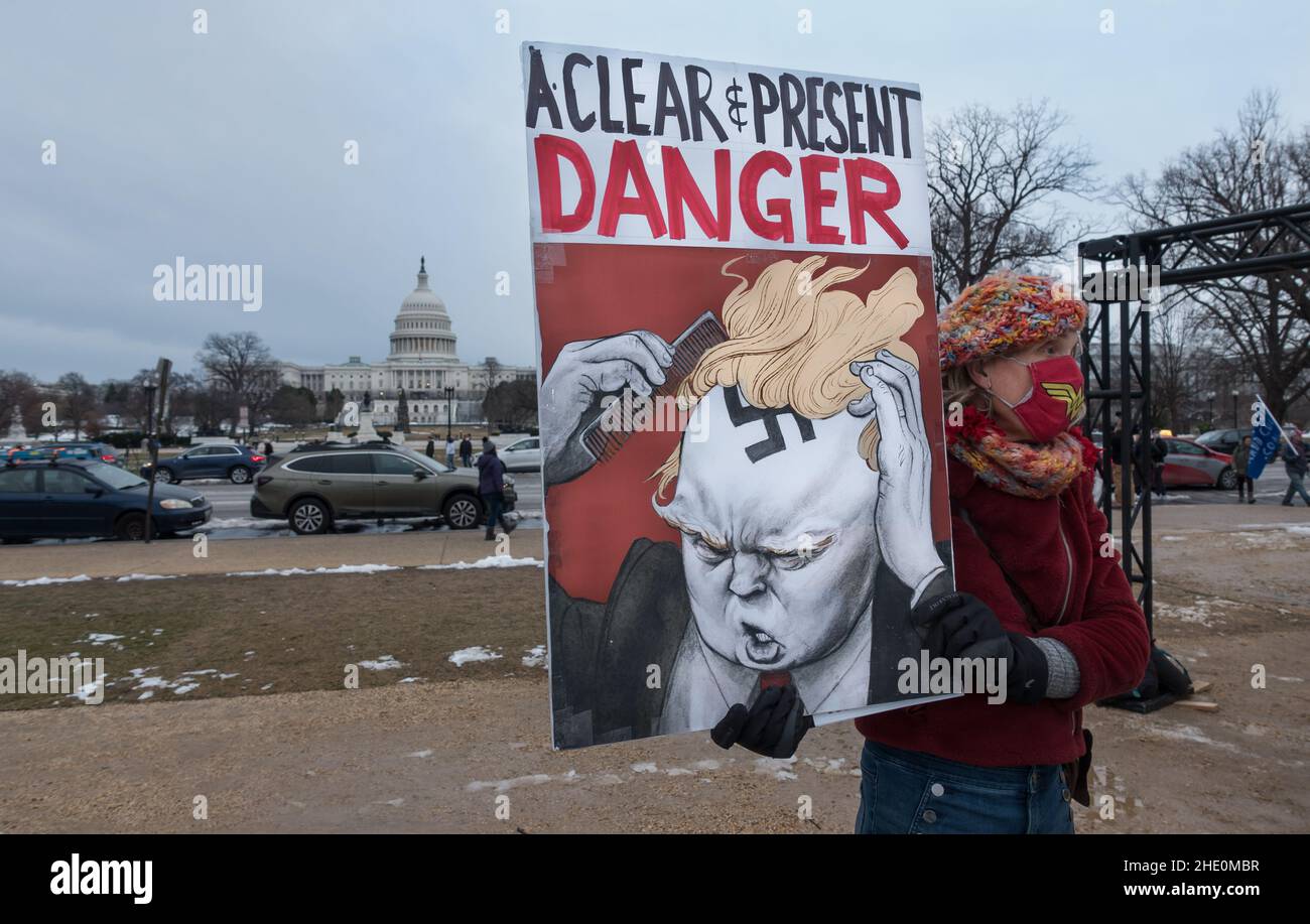 Demonstrator with explicit sign at Day of Remembrance rally near US Capitol, Jan. 6, 2022, on first anniversary of Trump instigated insurrection. Stock Photo