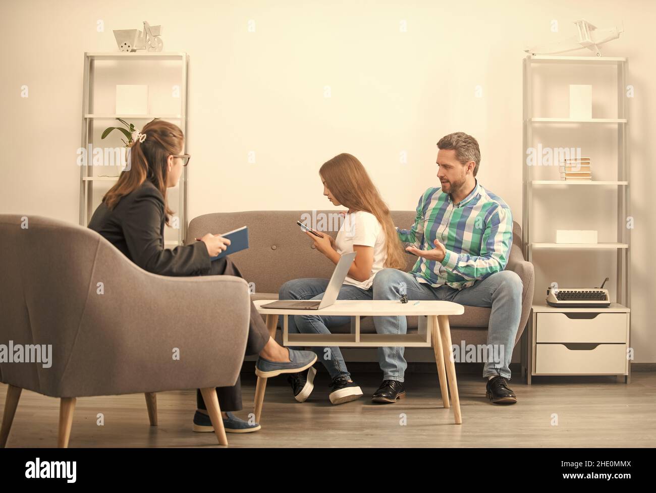 parenthood and fatherhood. kid and dad talk to social worker. interpersonal relations. Stock Photo