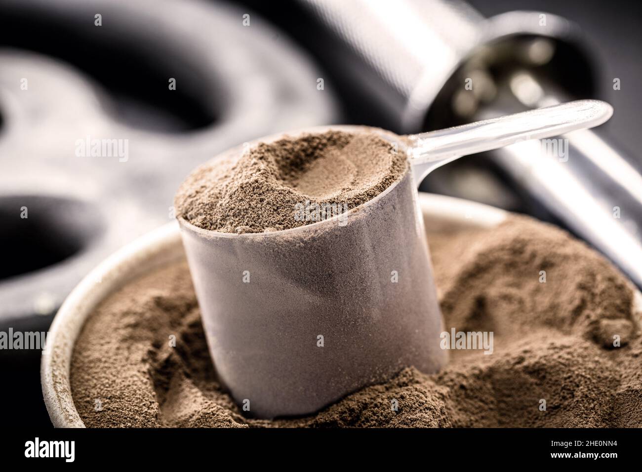 measuring spoon with casein and creatine, powdered food supplements