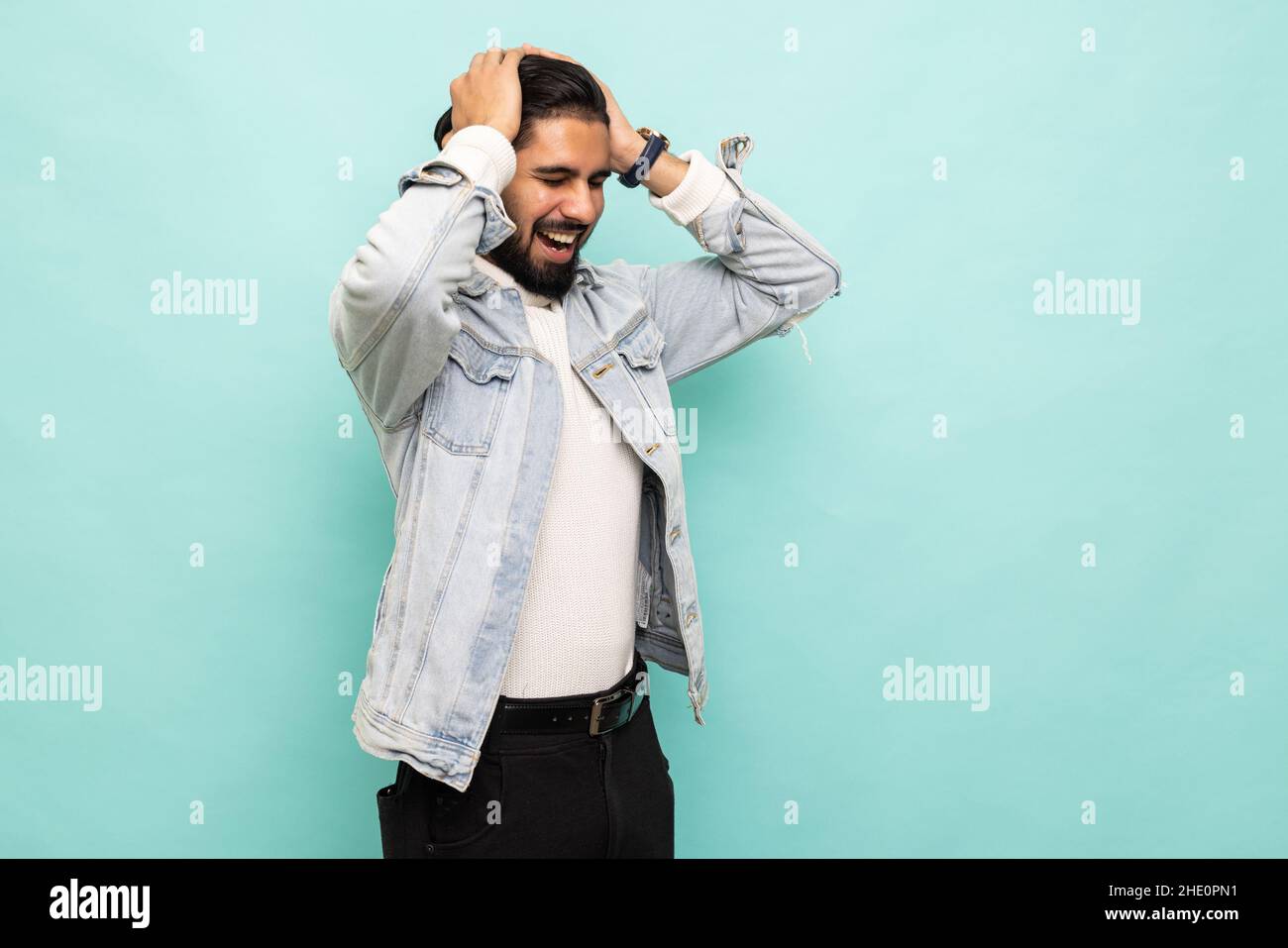 Angry man on turquoise background. Hate concept Stock Photo - Alamy