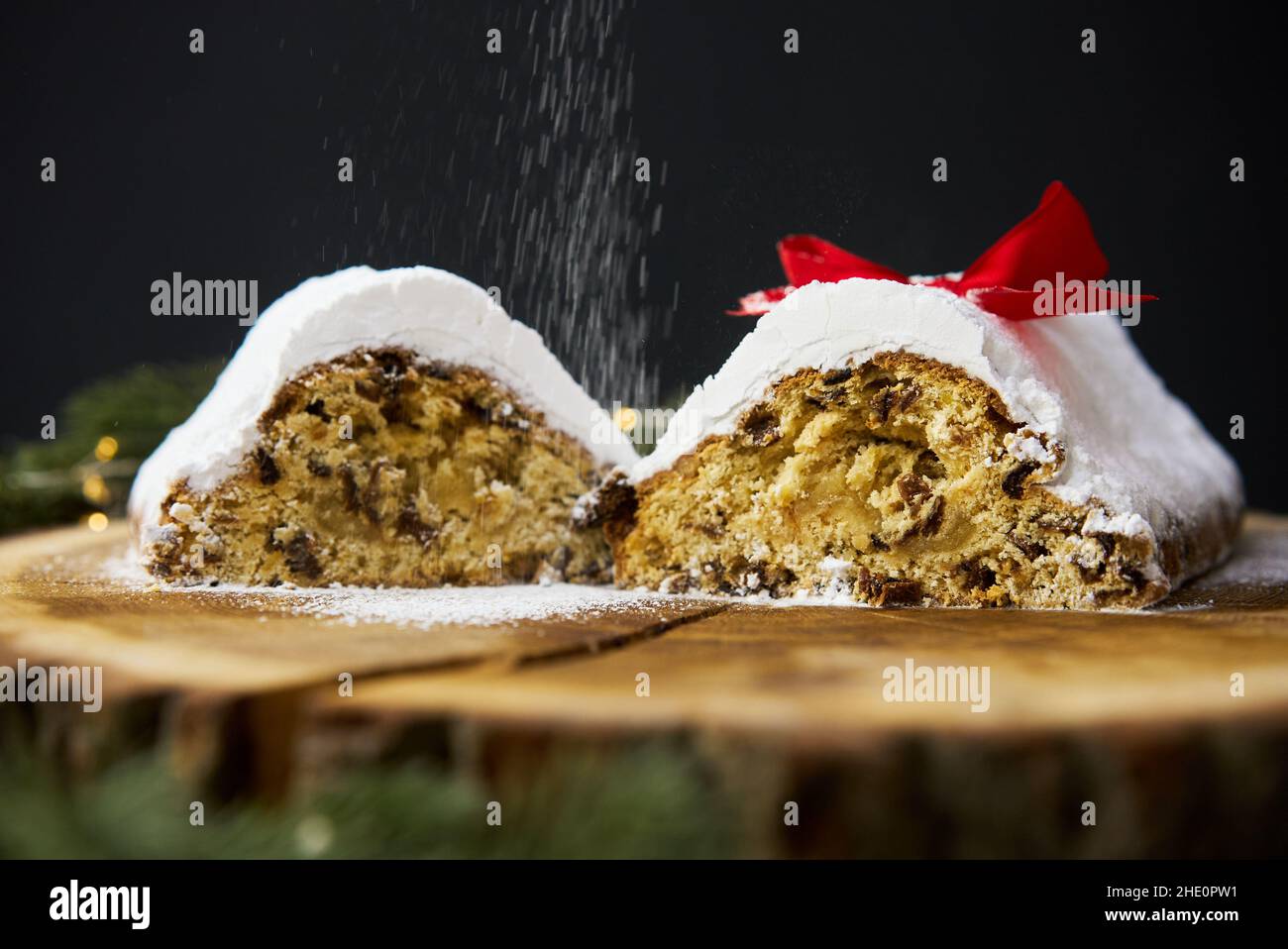 Traditional Christmas stollen made of dried fruits and nuts sprinkled ...