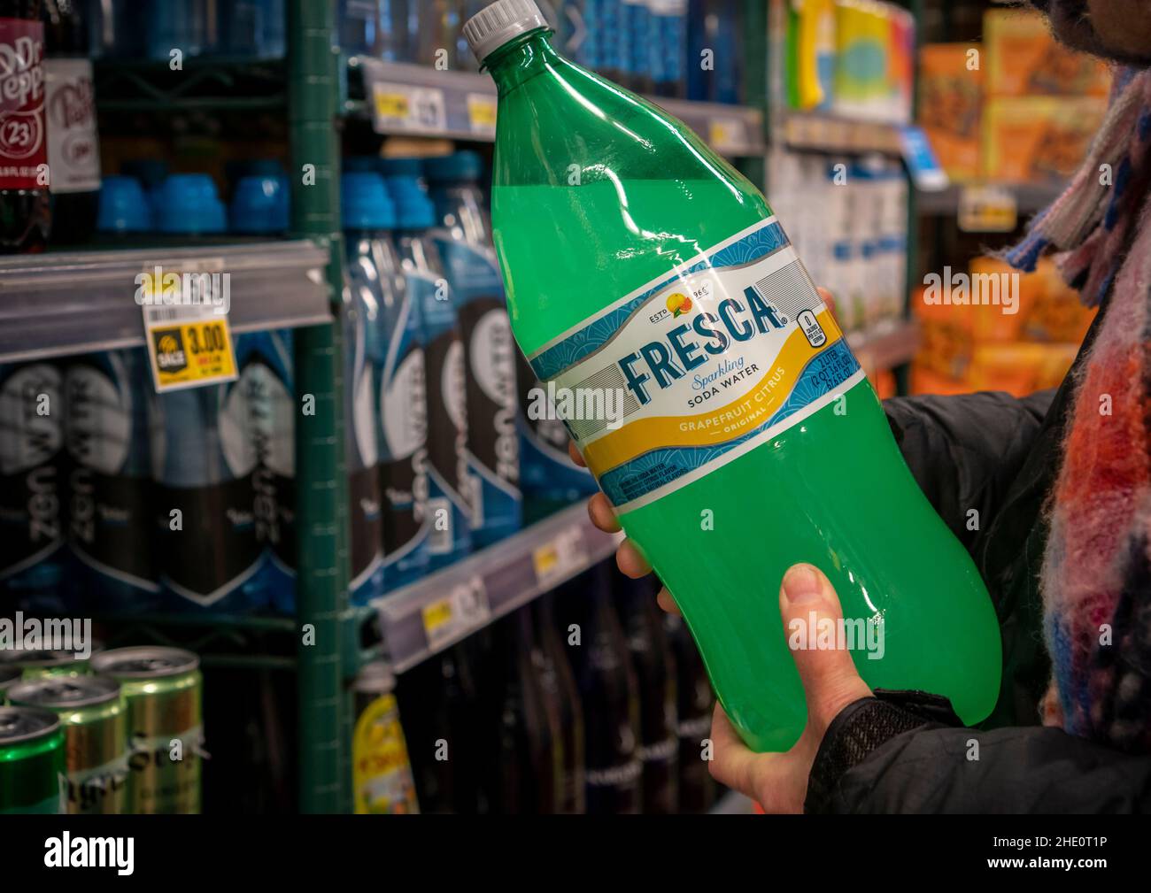 A discerning consumer chooses a bottle of Coca-Cola’s Fresca brand grapefruit-citrus flavored soda in a supermarket on Friday, January 7, 2022. The Coca-Cola Co. announced a partnership with Constellation Brands to create a Fresca alcoholic canned cocktail, entitled Fresca Mixed. (© Richard B. Levine) Stock Photo