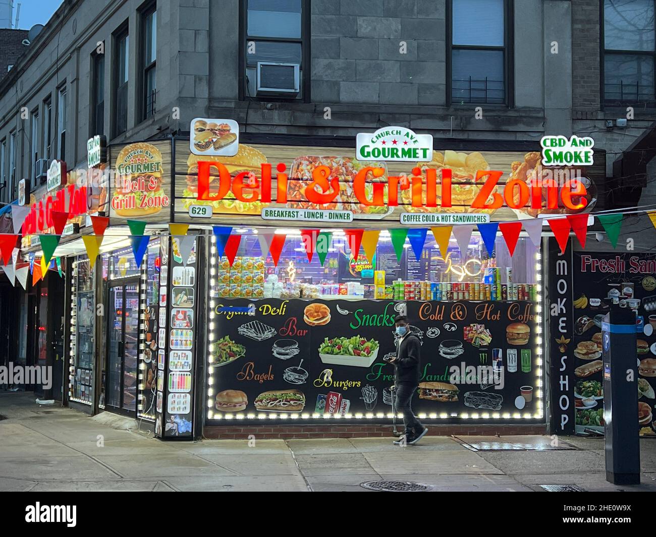 Neighborhood deligrill with enticing food advertising in the windows